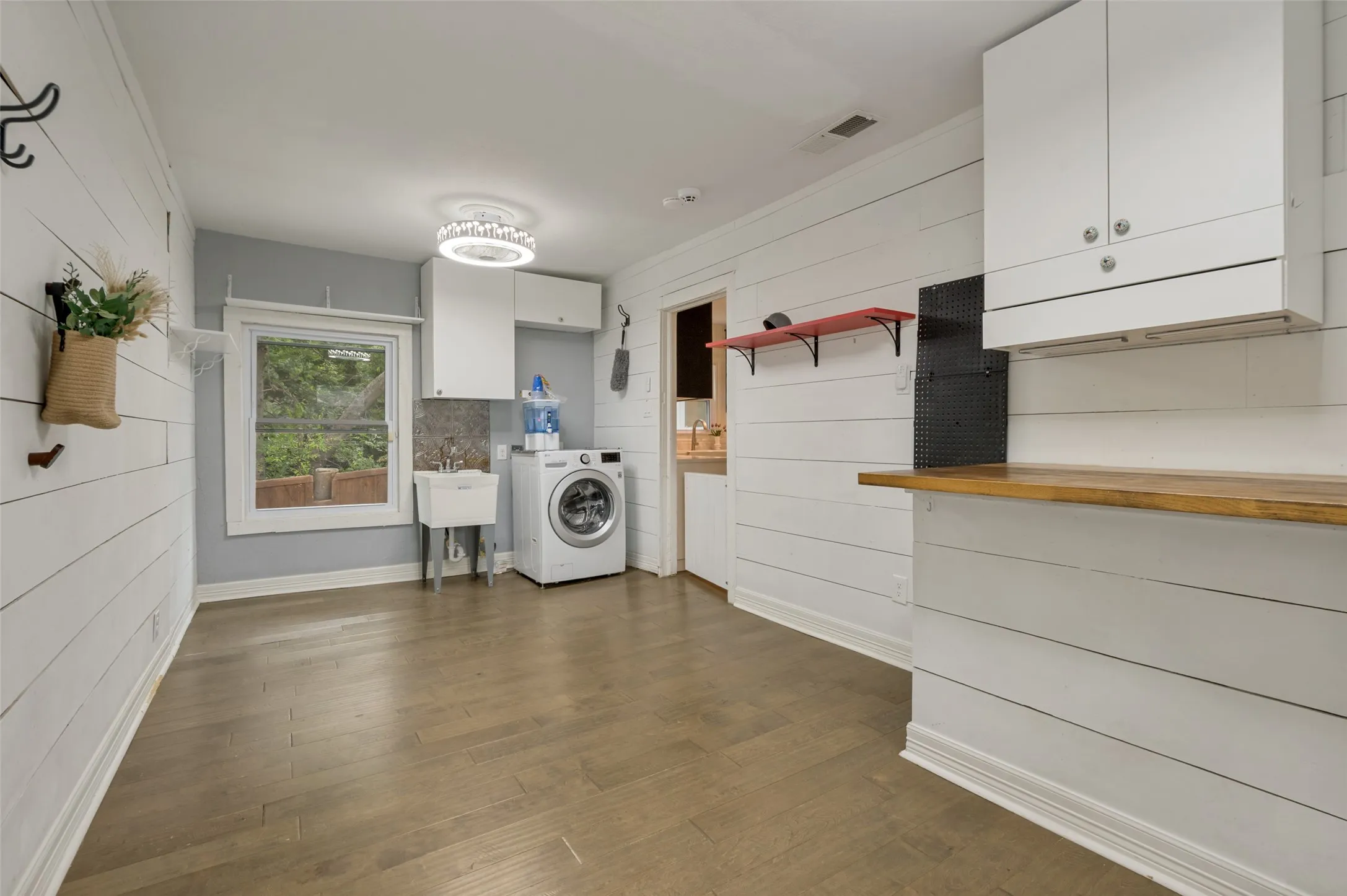 LAUNDRY SITS ON THE BACK OF THE HOME WITH ACCESS TO THE BACK DECK AREA