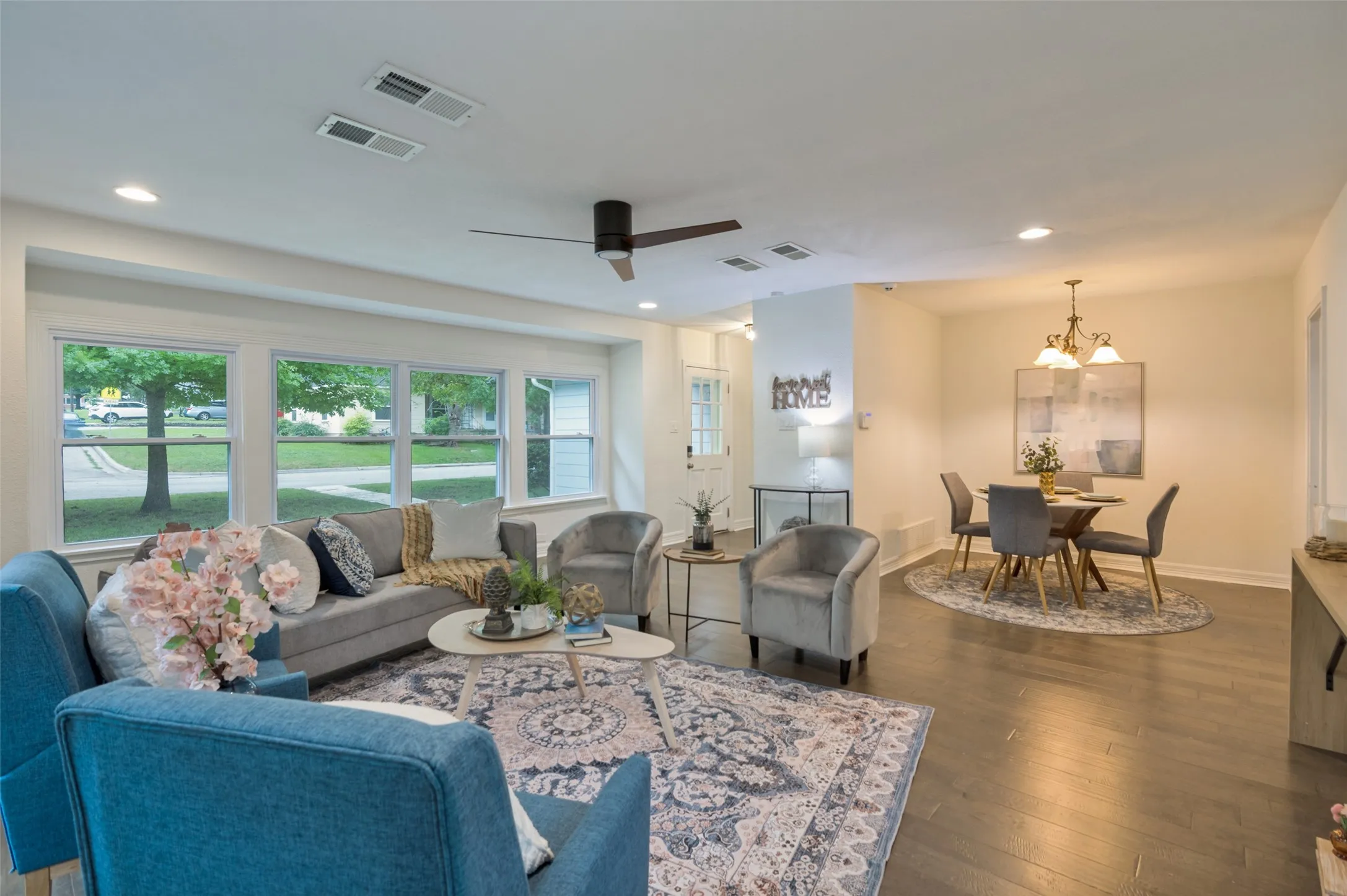 LIVING ROOM OVERLOOKS THE FRONT OF THE COTTAGE WITH ACCESS TO DINING AREA PROVIDING AN OPEN CONCEPT SPACE