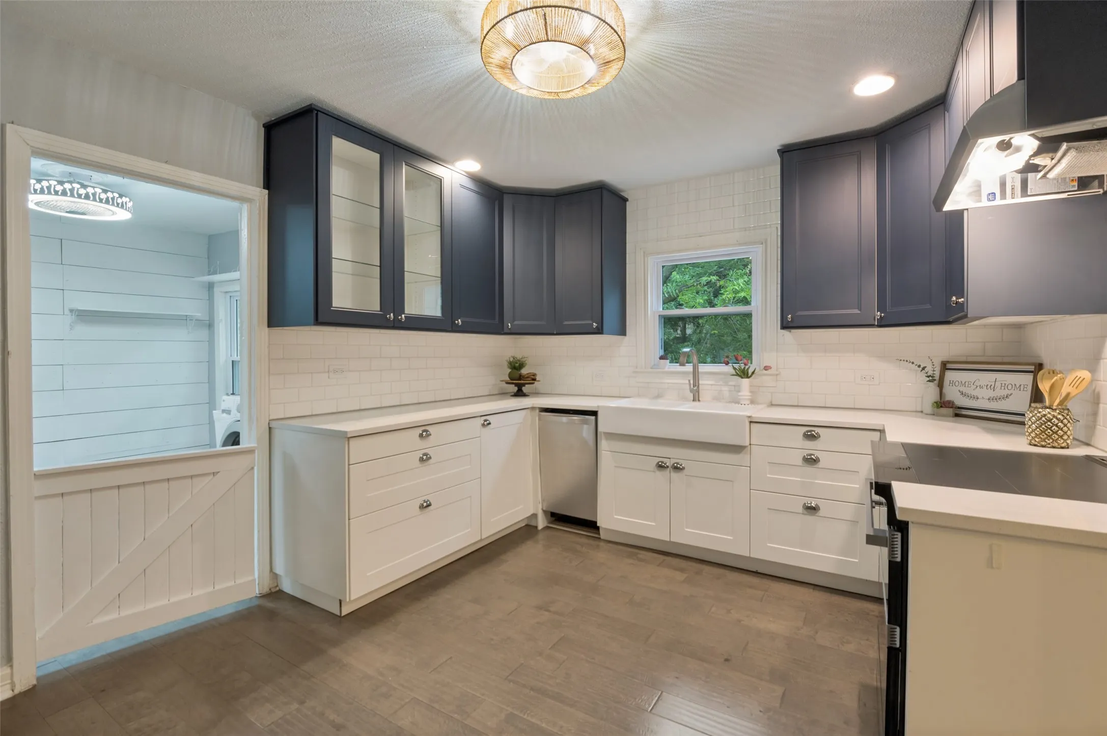 THE KITCHEN OVERLOOKS THE SIDE OF THE HOME WITH ACCESS TO LIVING AND DINING AND ACCESS TO THE LAUNDRY ROOM THROUGH THE GATE