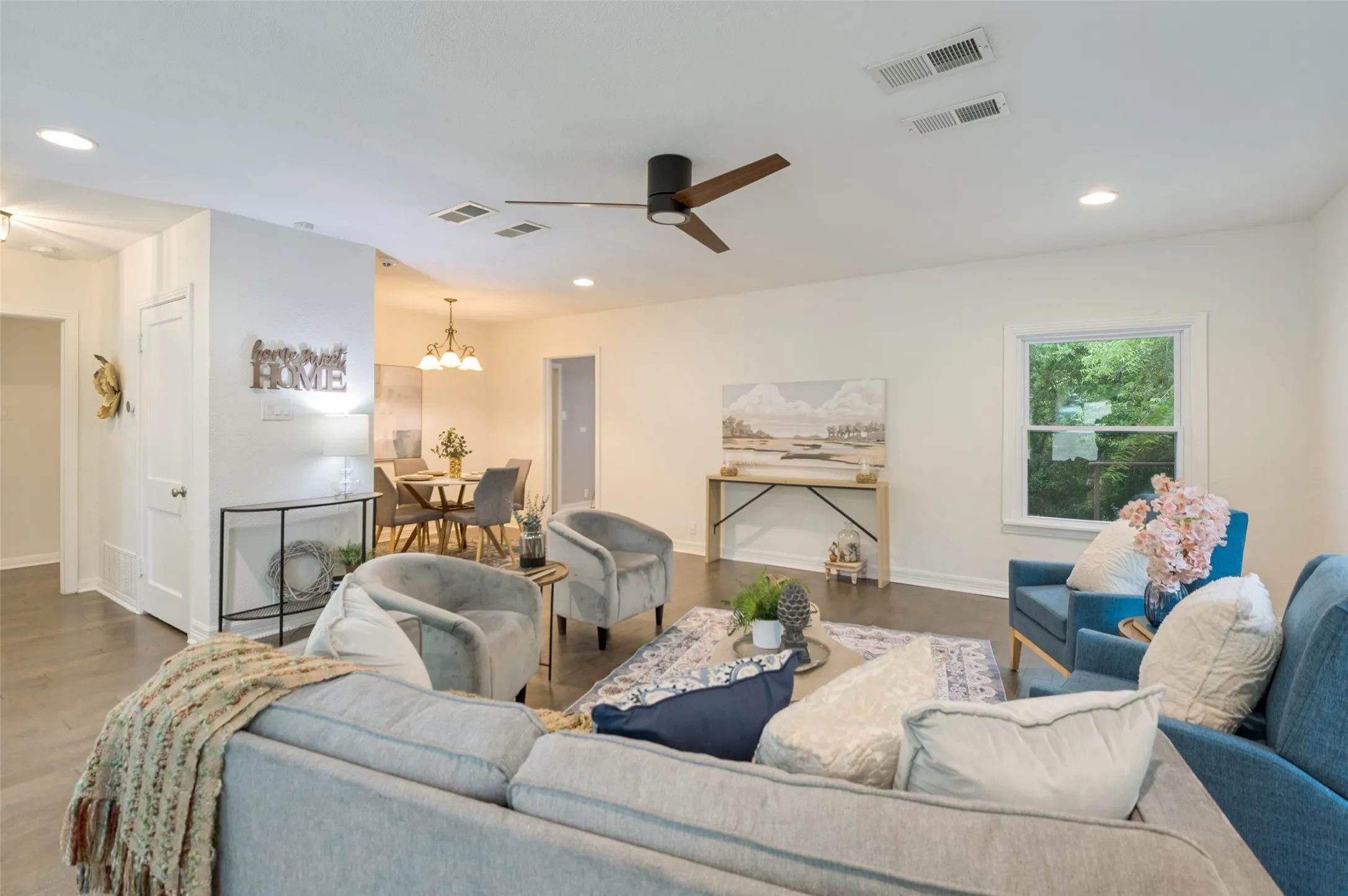 LIVING AREA SITS ON THE FRONT OF THE HOME WITH ABUNDANT LIGHTING