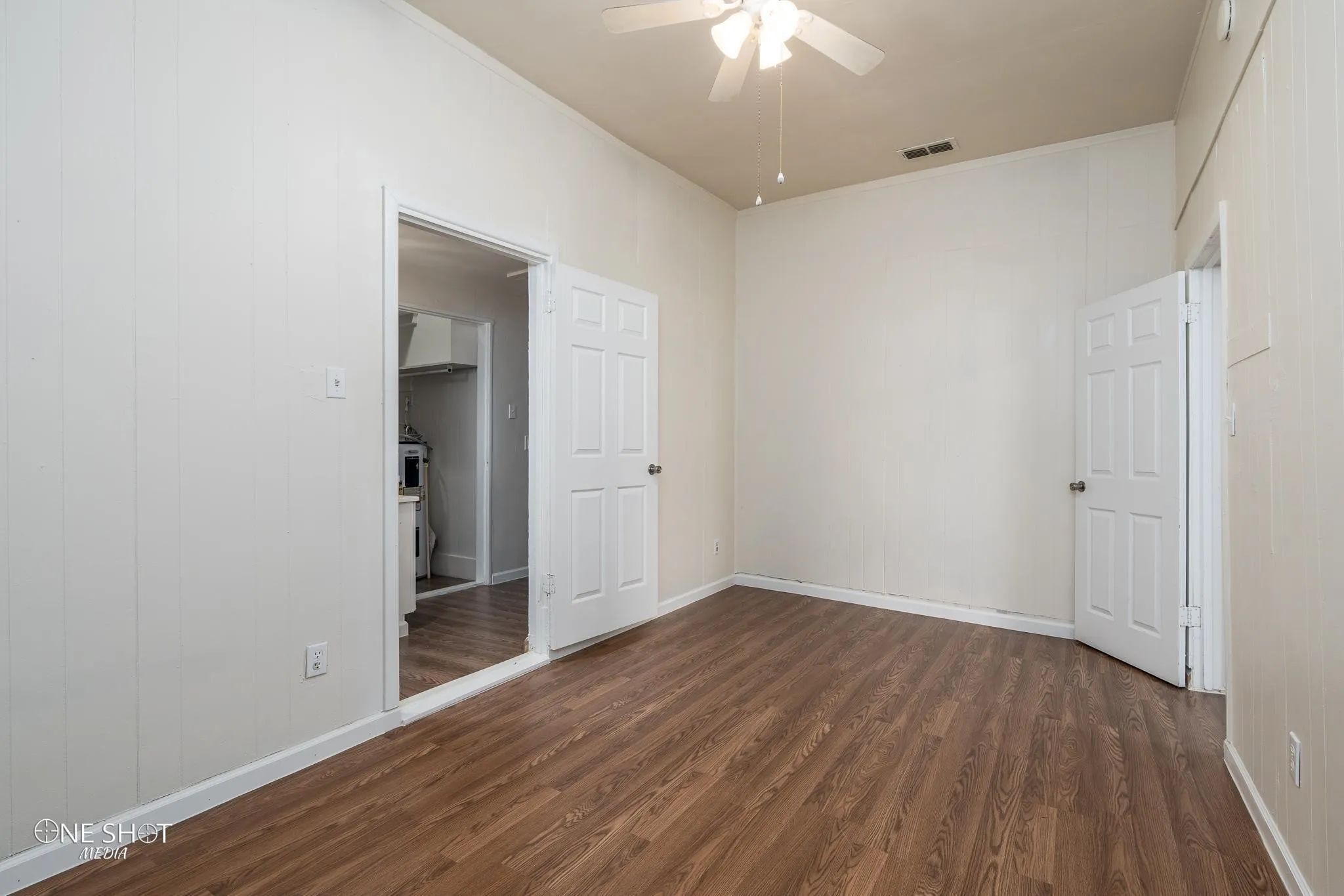 Spare room with ceiling fan and dark hardwood / wood-style floors
