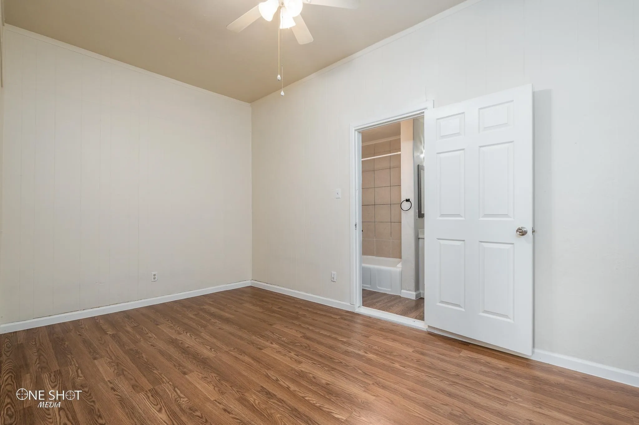 Unfurnished room featuring hardwood / wood-style flooring and ceiling fan