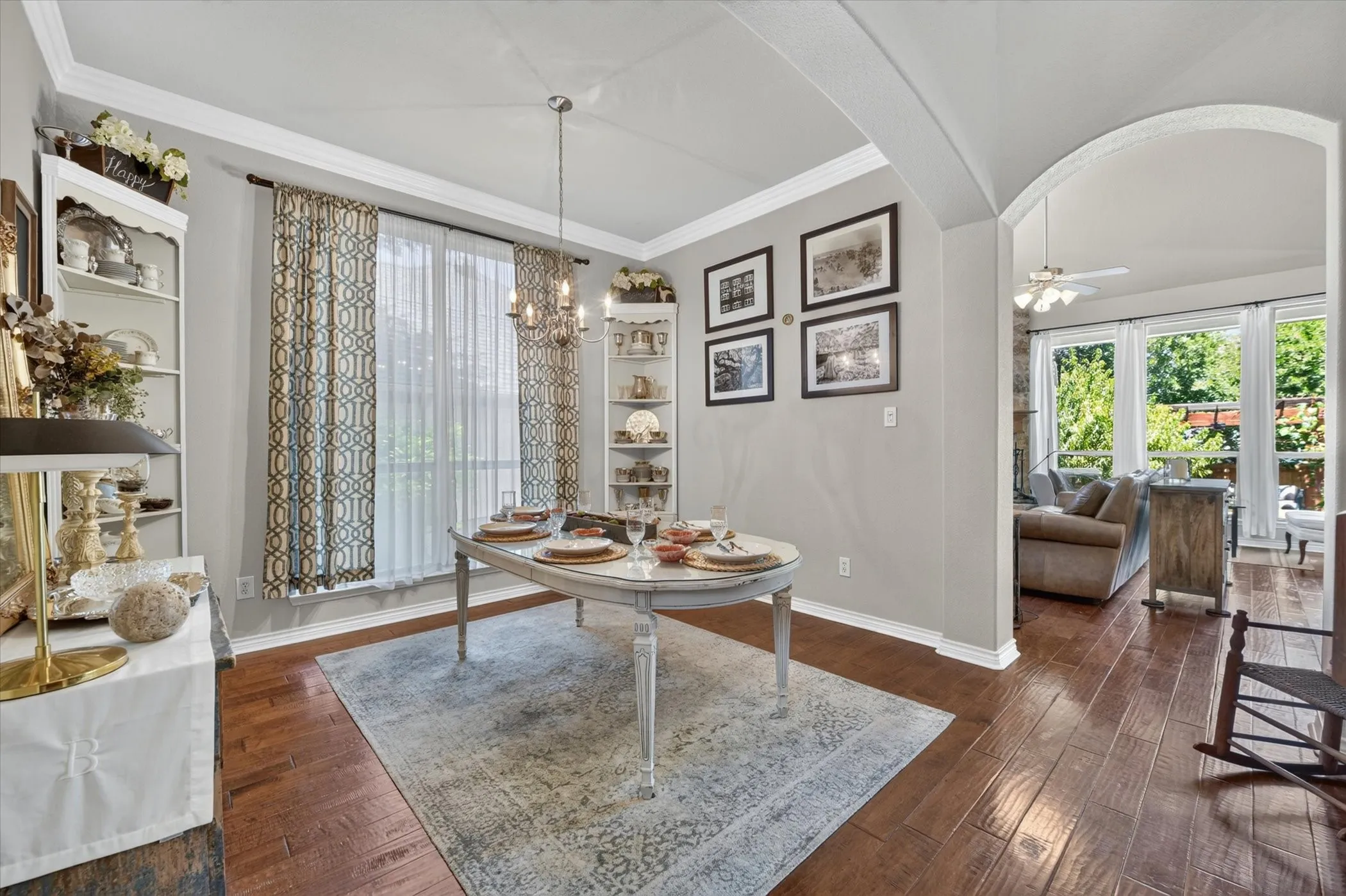 Formal dining area featuring wood-finish flooring, crown molding, and a chandelier light fixture