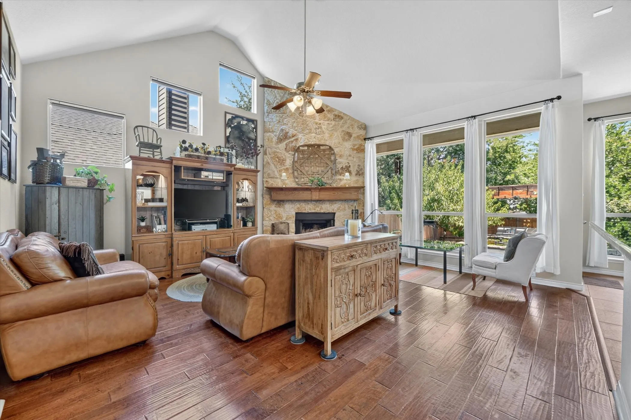 Vaulted ceilings complement wood-finish flooring in this living space