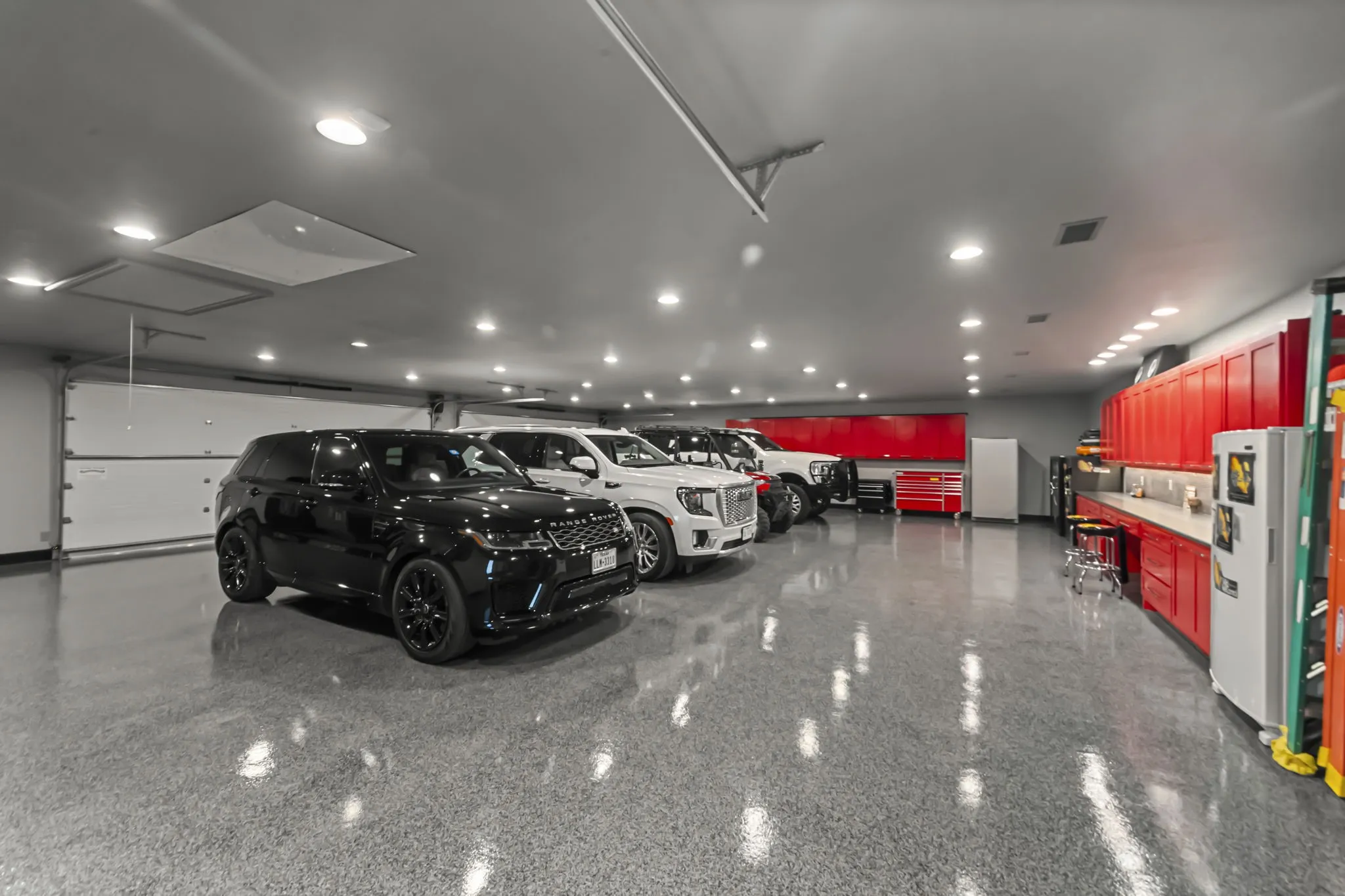 Huge climate controlled primary garage with built ins and epoxy floor