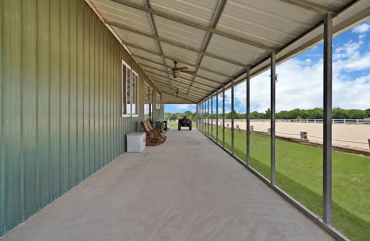 Full length of barn, shaded with a breeze to kick back and watch em ride