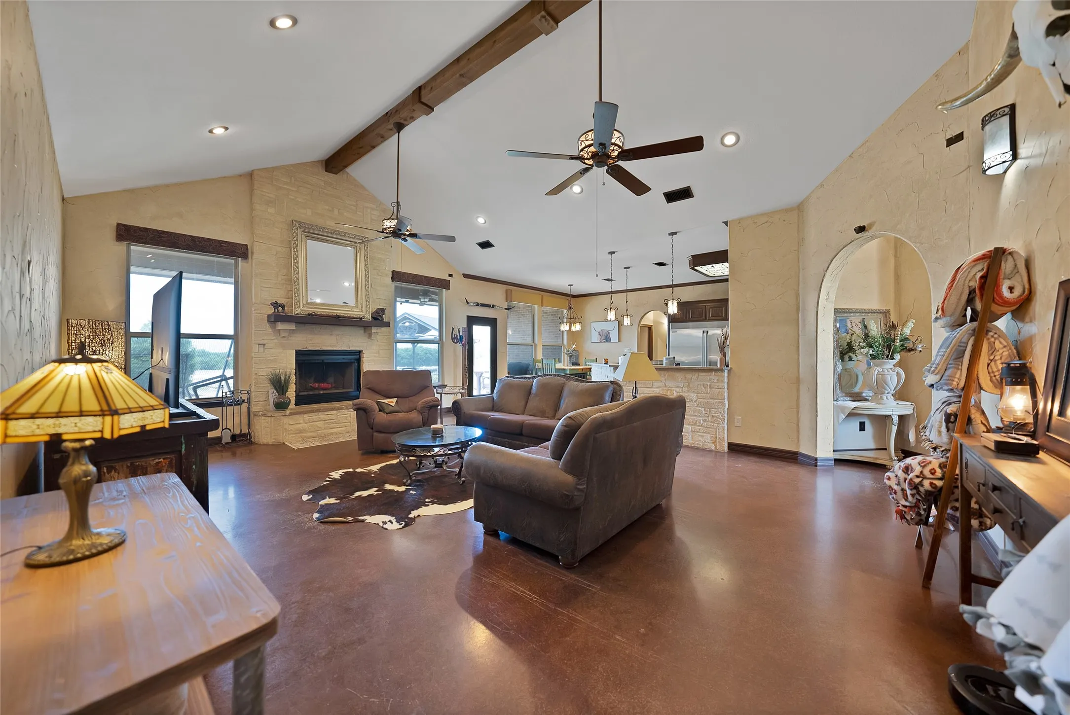 Soaring ceiling, full stone fireplace and arched doorways