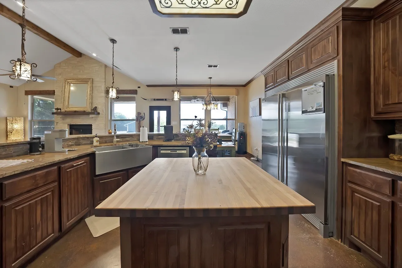 Breakfast bar, SS farm apron sink, butcher block top island, Electrolux appliances, built in commercial grade refrigerator