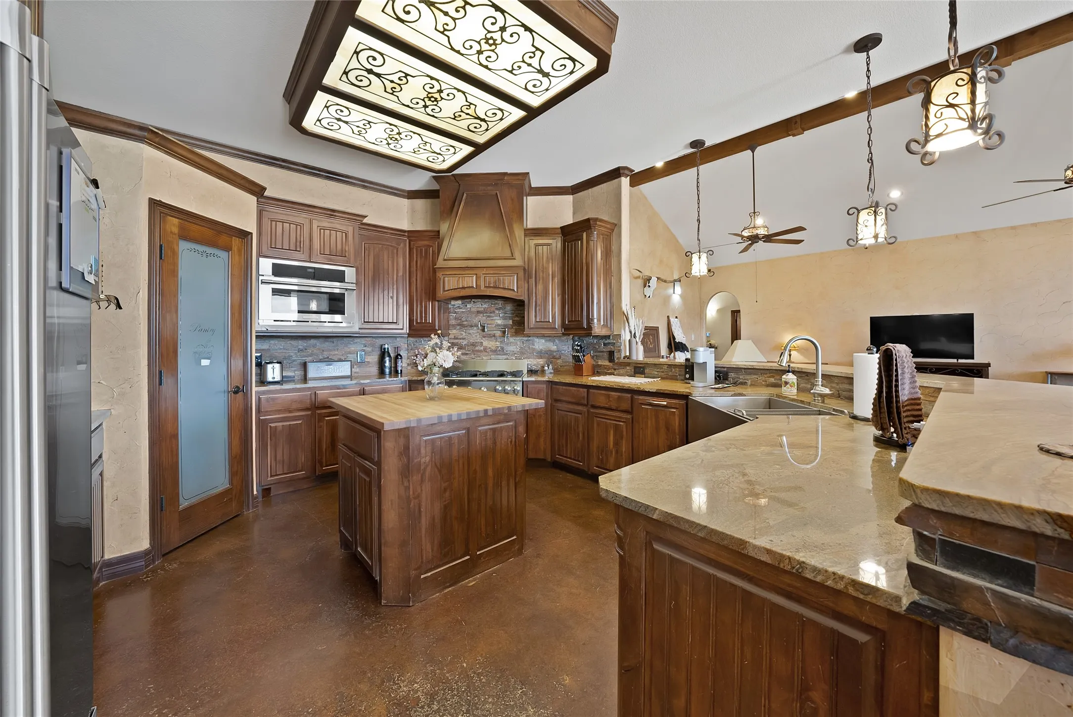 Chef's kitchen, walk in pantry, commercial gas range with pot filler and designer fixtures