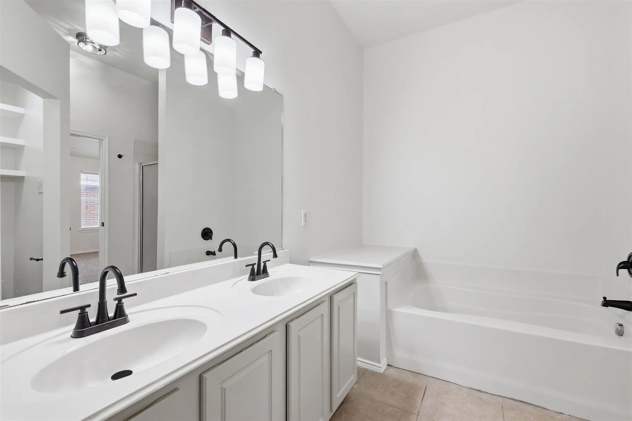 Master bath with his/hers sinks, garden bathtub, separate shower and walk in closet