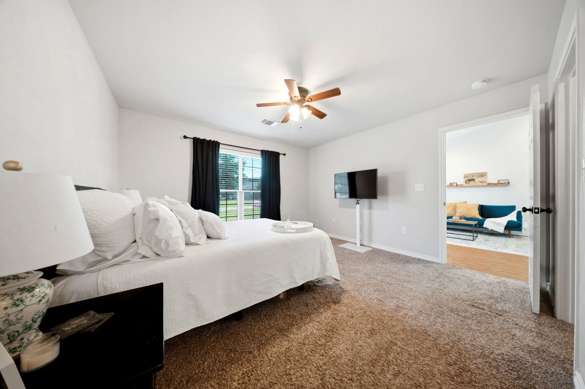 Large primary bedroom offers plenty of room for oversized furniture and additional seating.