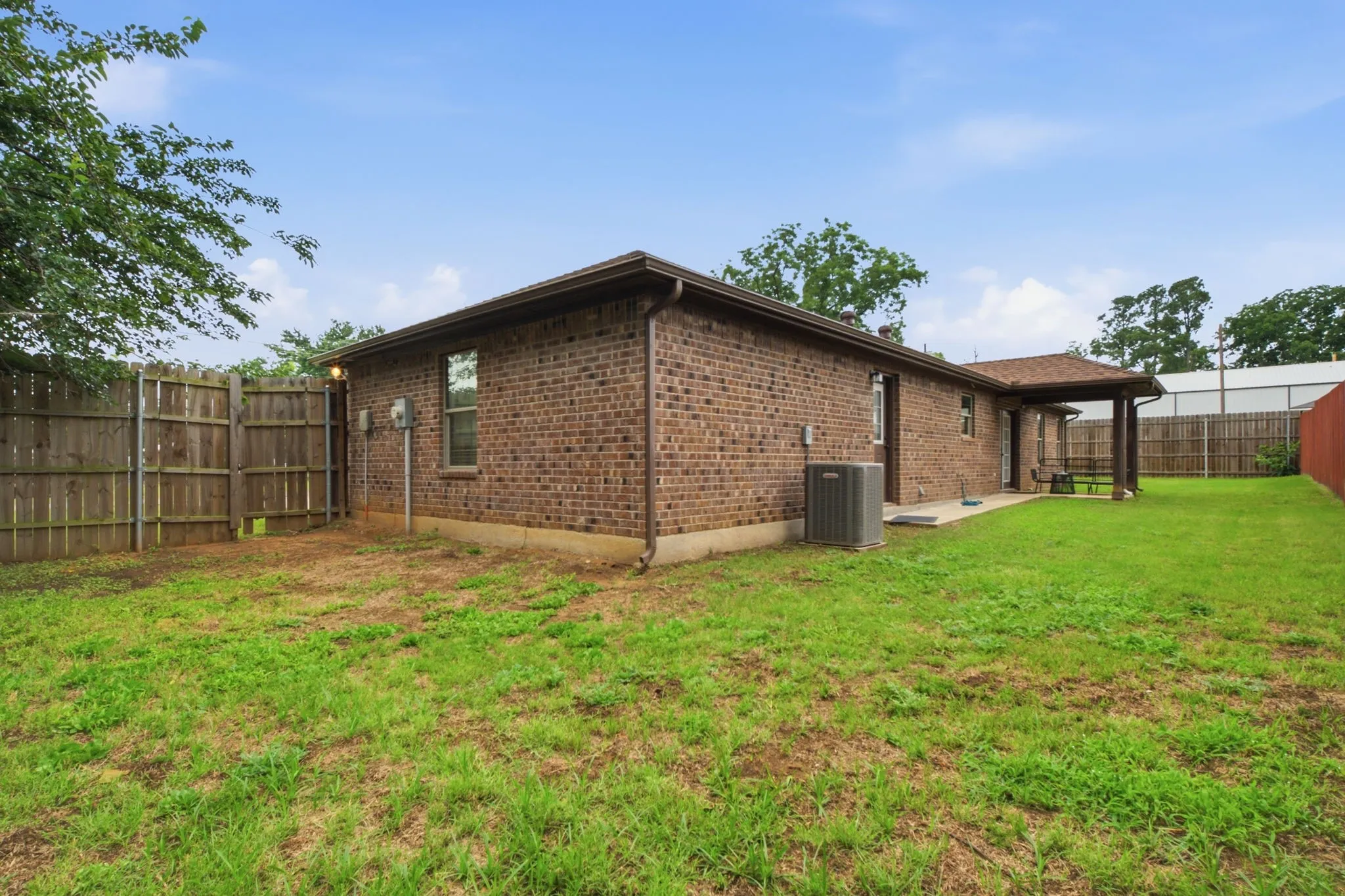 Low-maintenance brick exterior with a spacious yard and plenty of room to enjoy outdoor living.