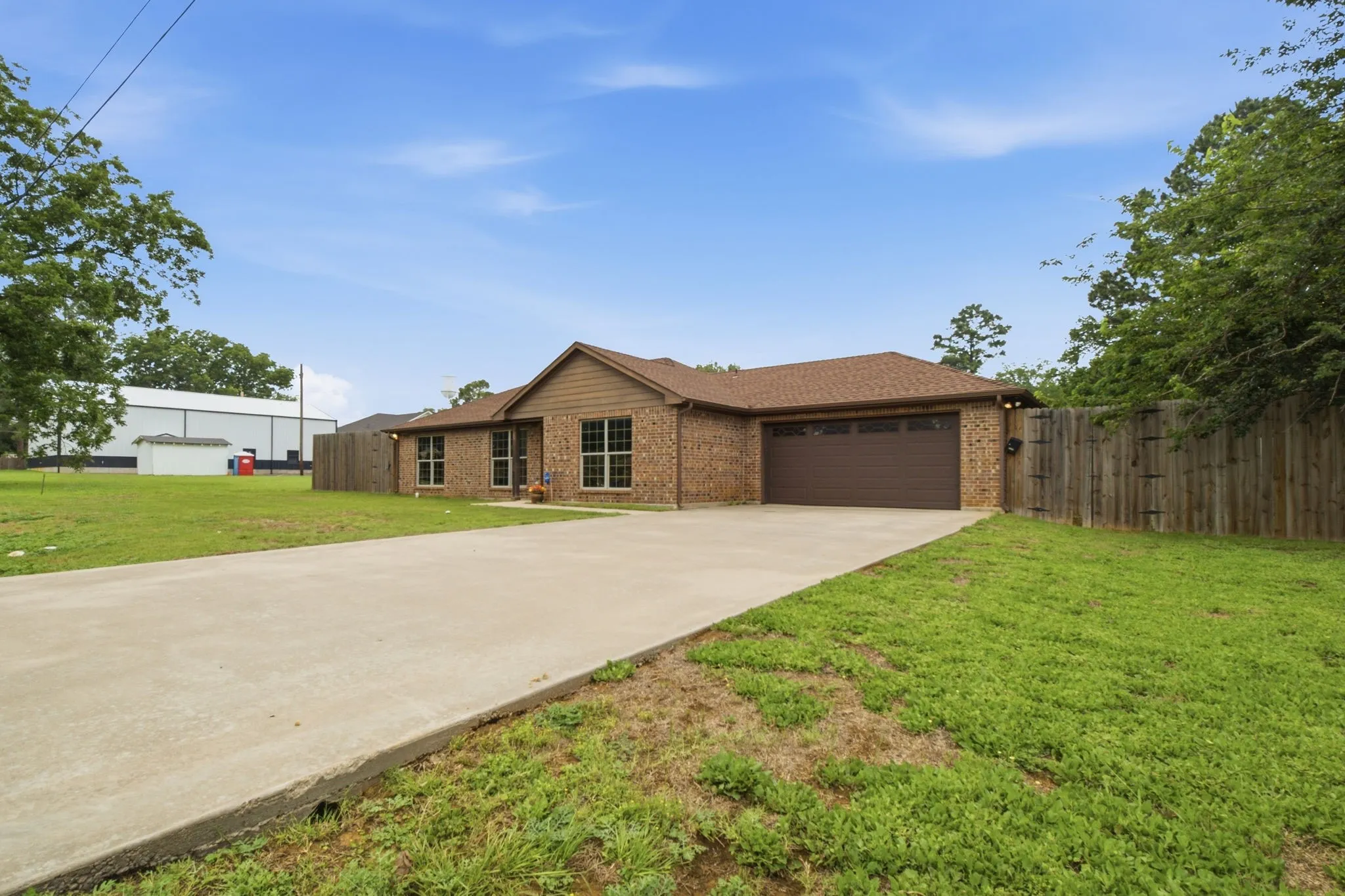 Extended concrete driveway leads to the attached two-car garage with ample parking for family and guests.