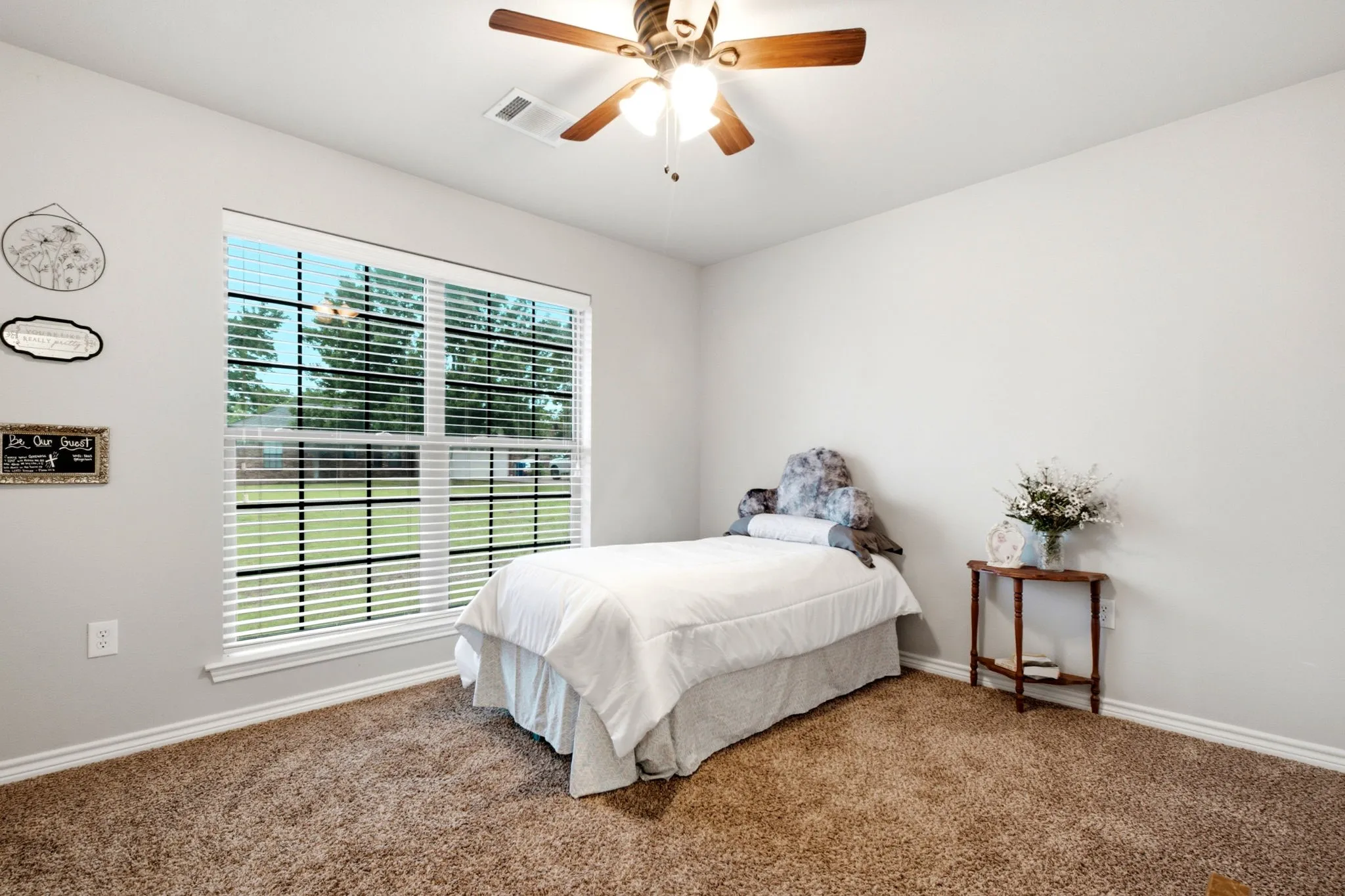 Spacious secondary bedroom featuring large windows, abundant natural light, plush carpet, and generous wall space for flexible furniture arrangements.