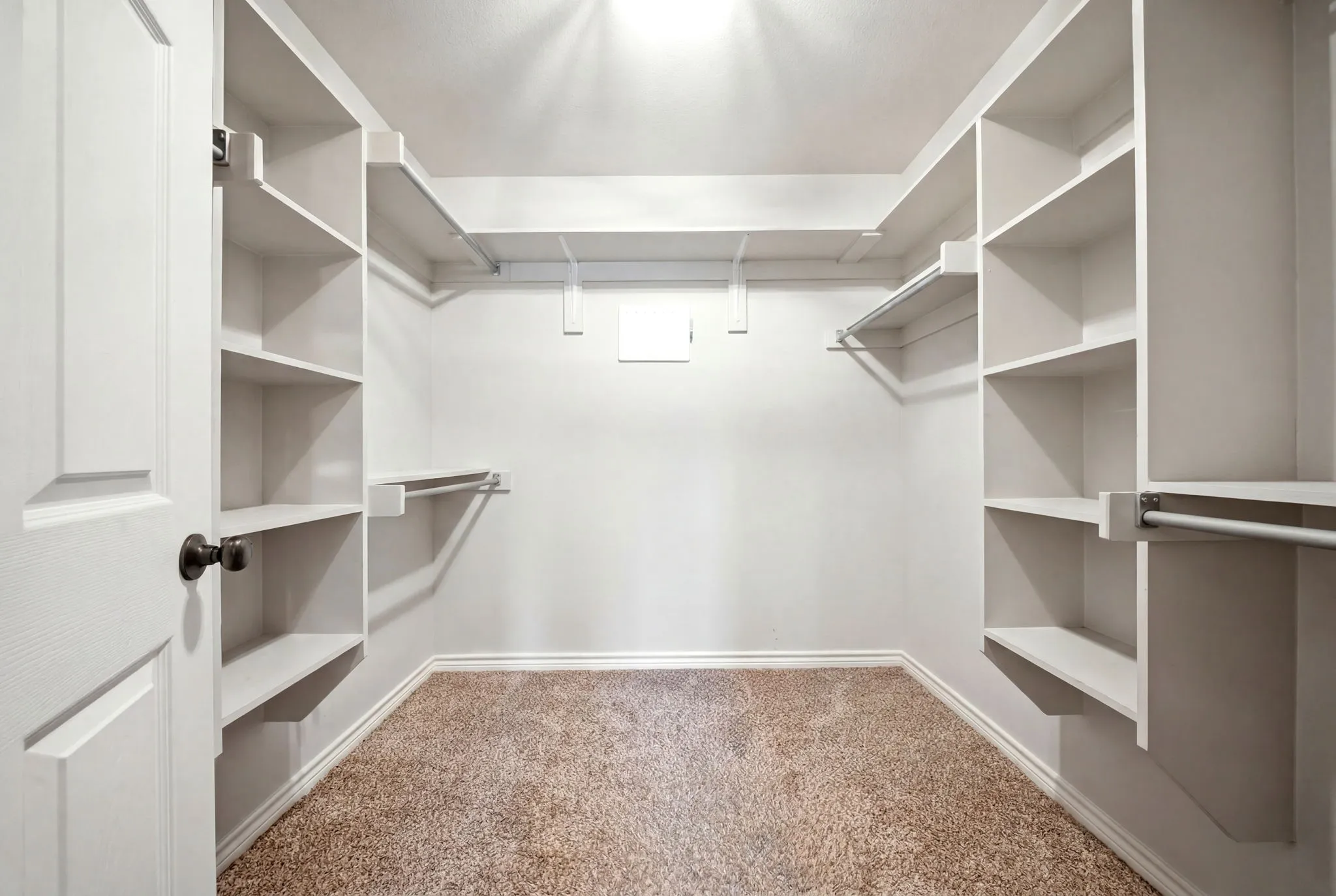 Oversized custom walk-in closet with extensive shelving and storage solutions.