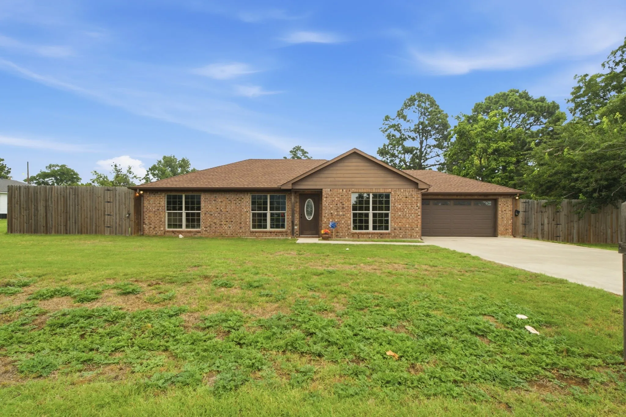 Attractive front elevation featuring a low-maintenance brick exterior, newer roof installed in 2024, and oversized lot.
