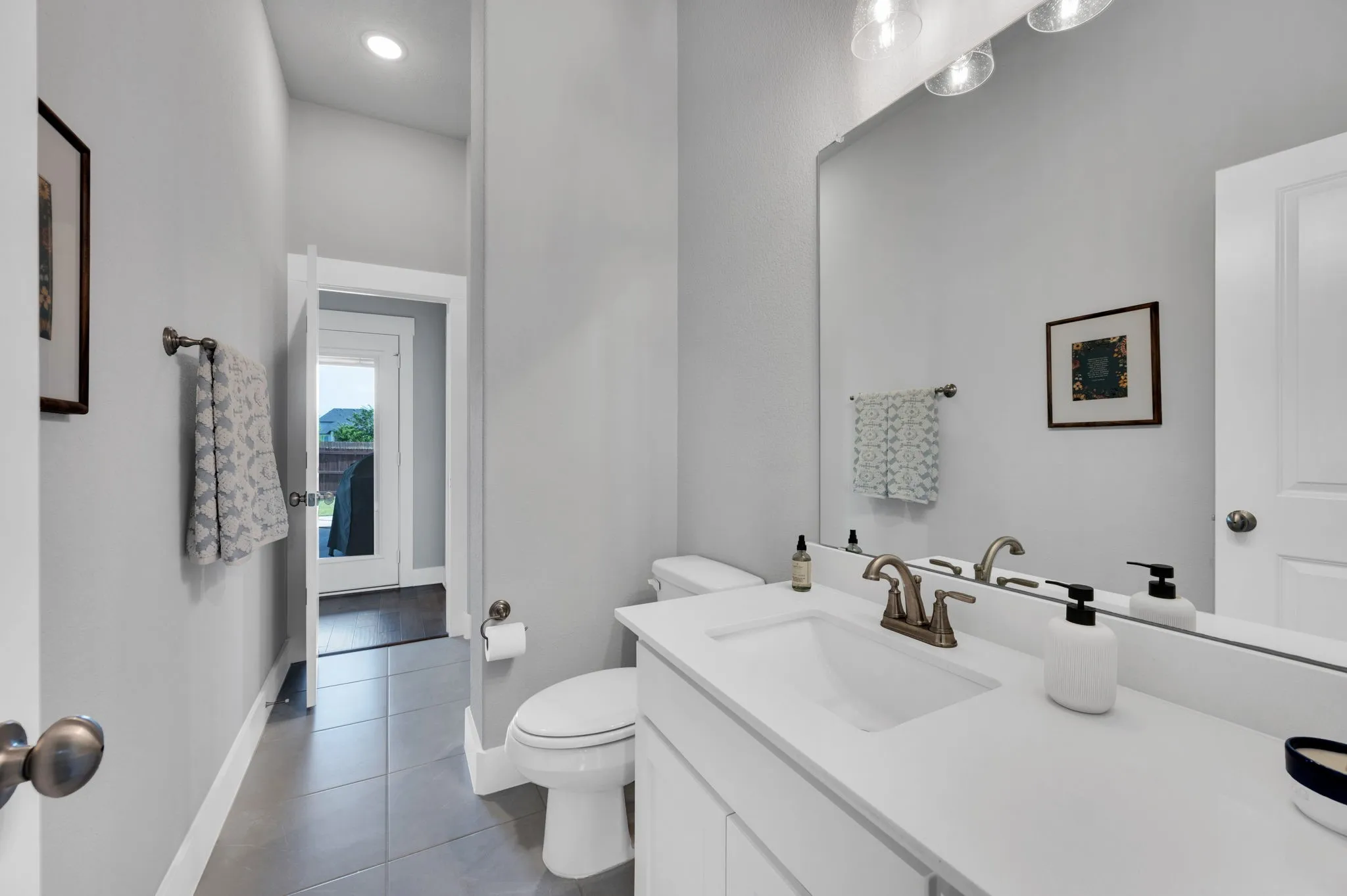 Bedroom featuring a tray ceiling with a ceiling fan, dark wood-finish flooring, and white baseboards