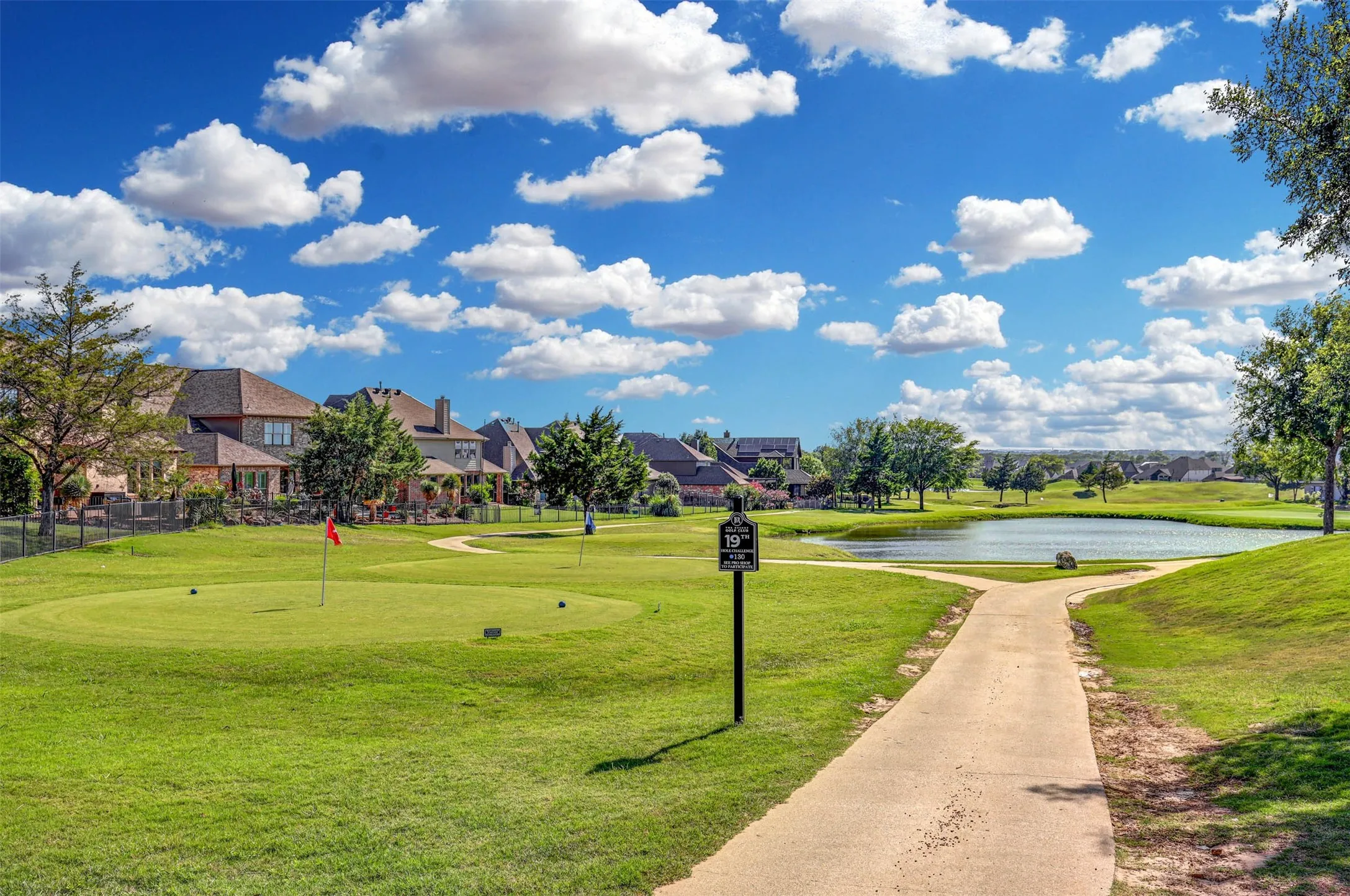 Community pond with putting practice area for relaxed outdoor enjoyment.