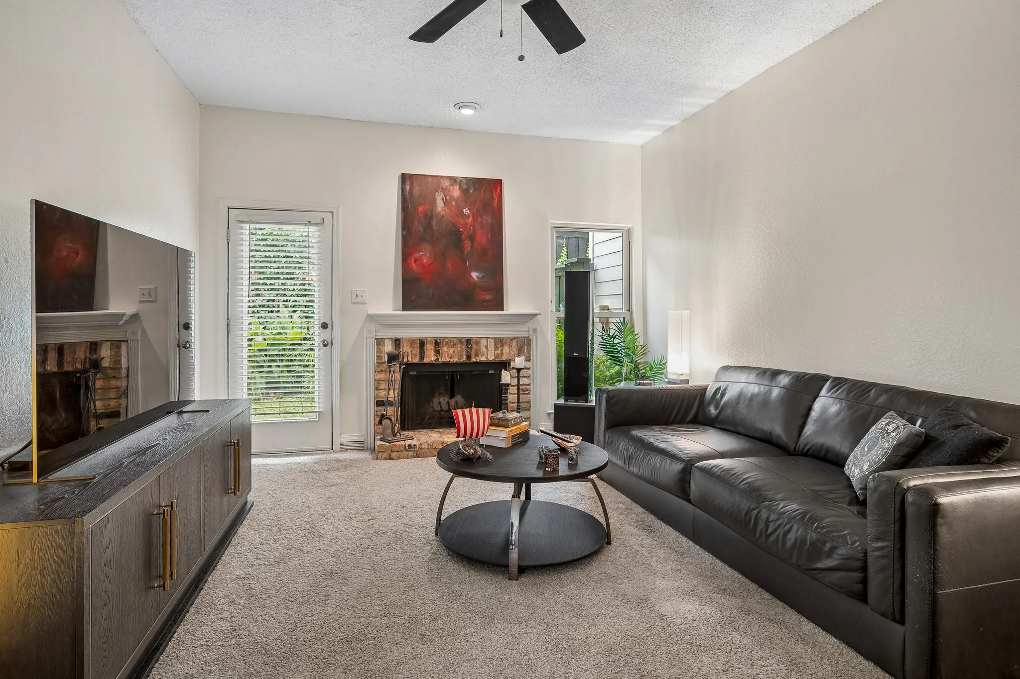 Living area with ceiling fam and WBFP.