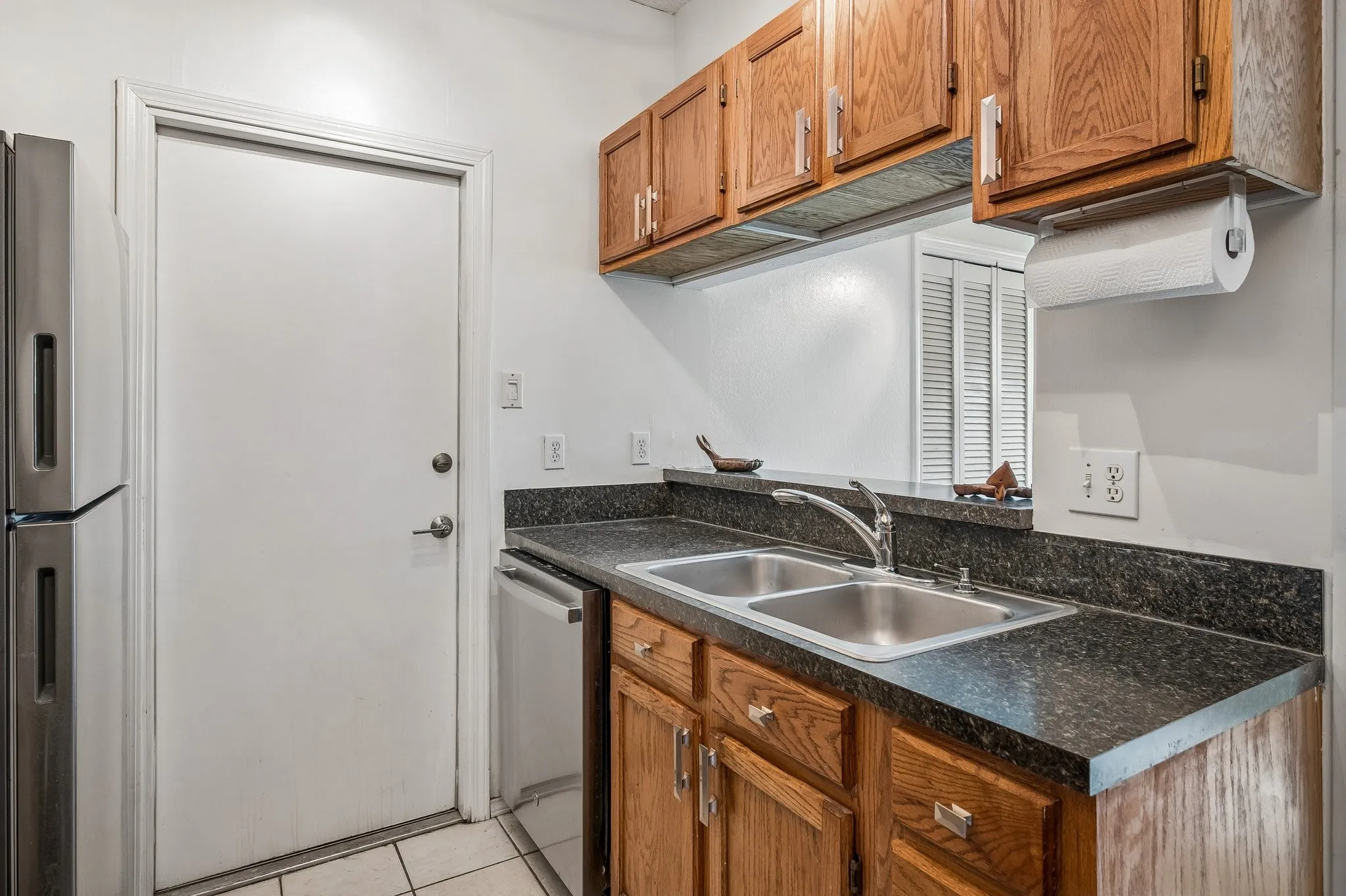 Kitchen with breakfast bar overlooking dining area.