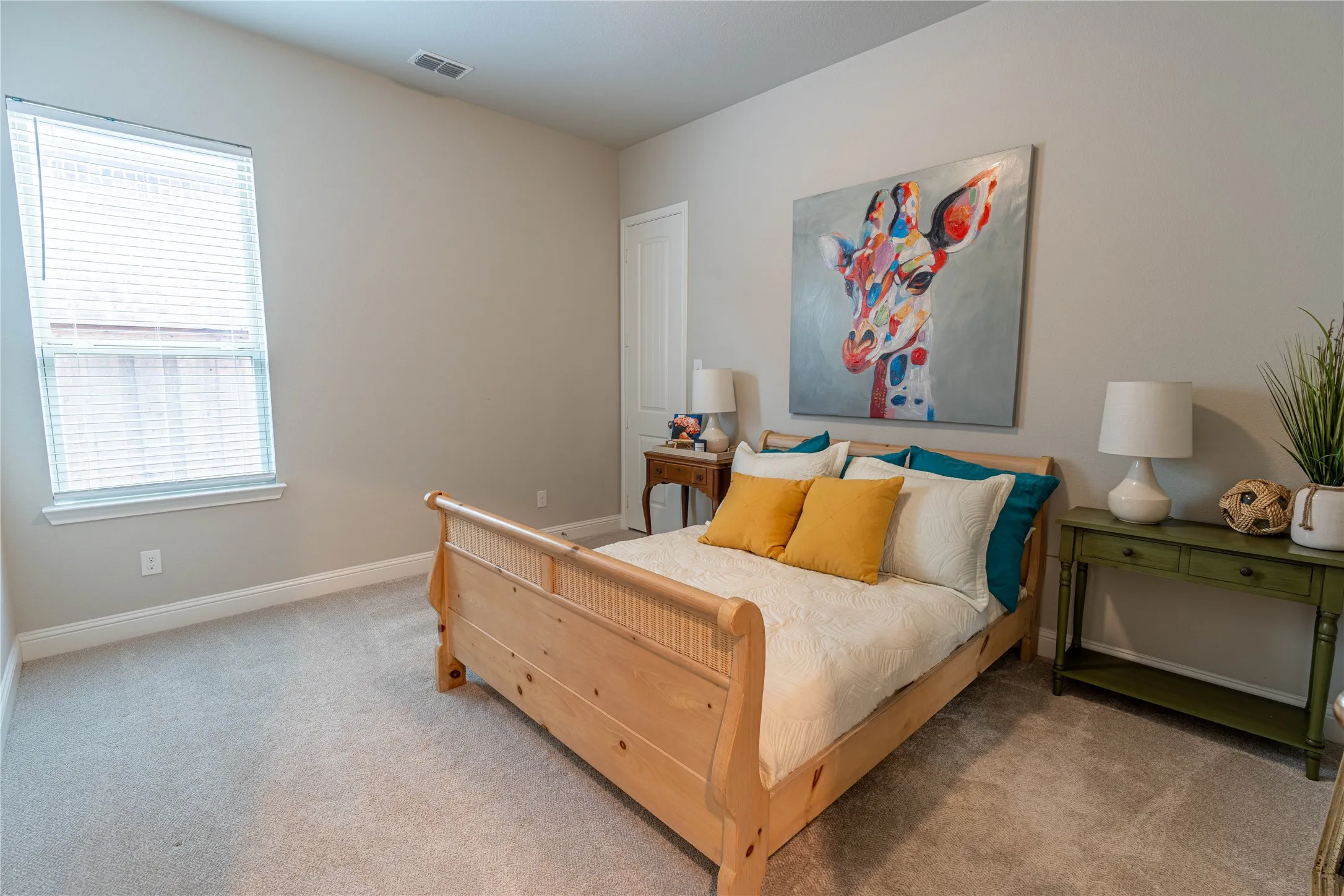 Room featuring a single window with blinds, light-colored carpeting, neutral painted walls, and white trim