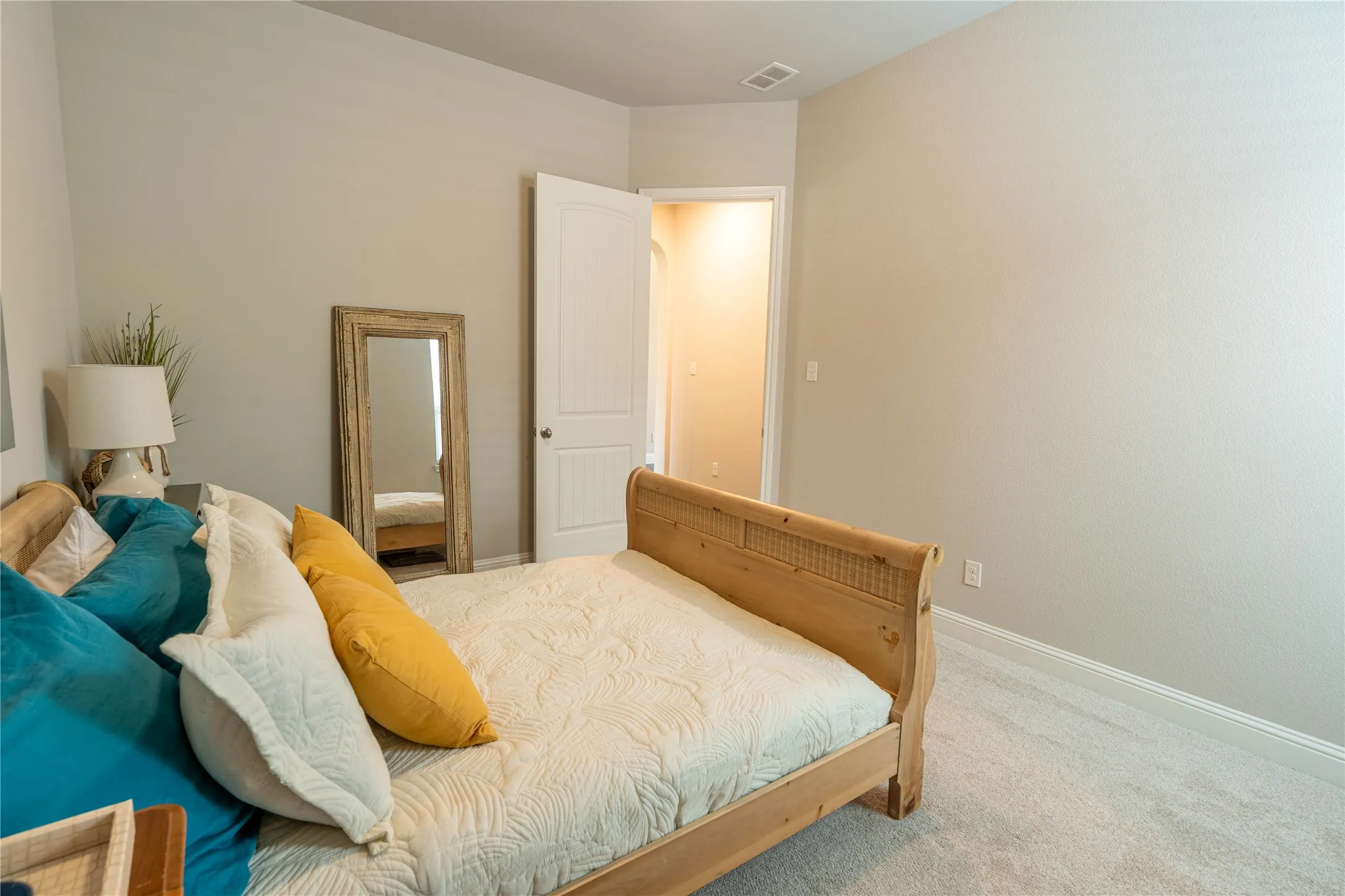Wall-to-wall carpeting in a neutral tone, complemented by light gray wall paint and white baseboards