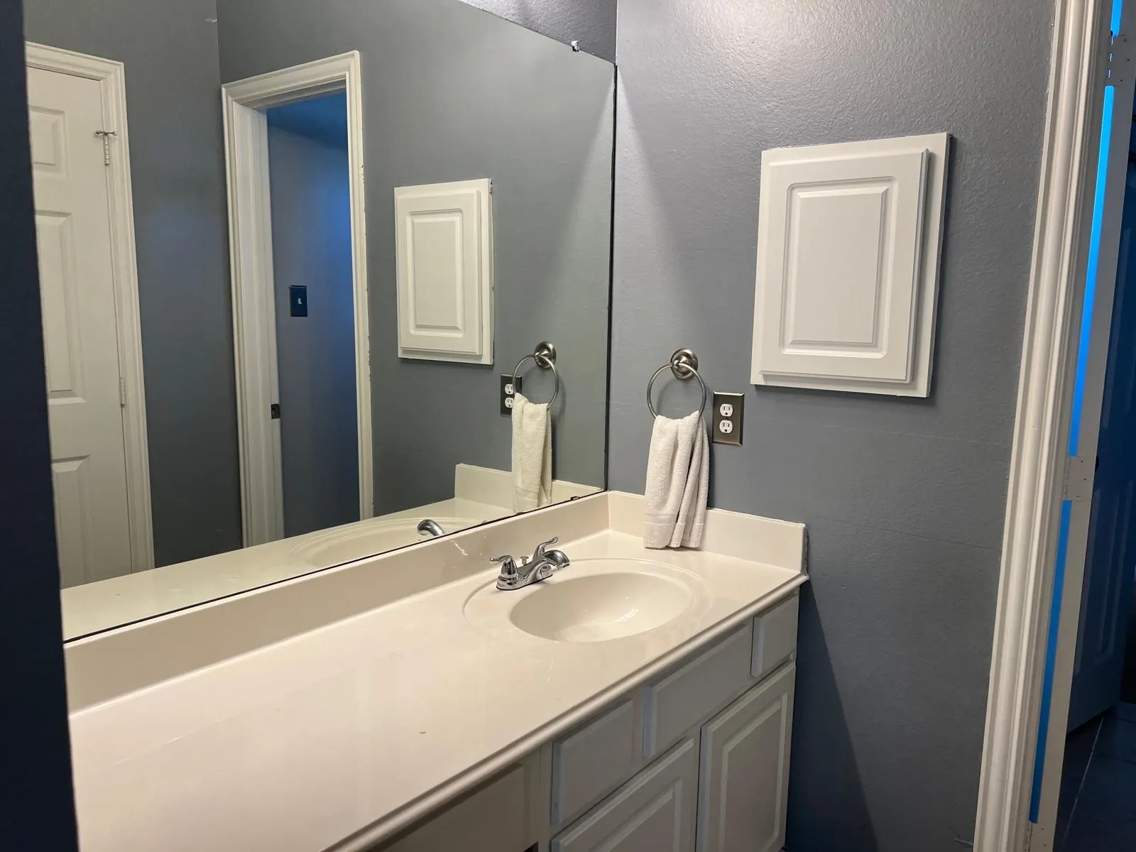 Vanity area featuring a built-in sink, chrome faucet, and integrated mirror
