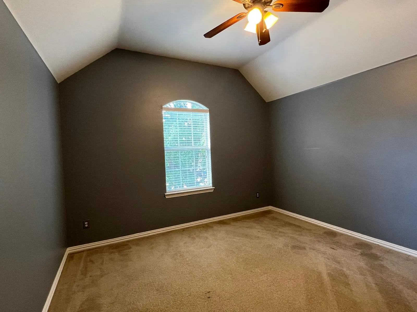 Room with vaulted ceilings and a ceiling fan