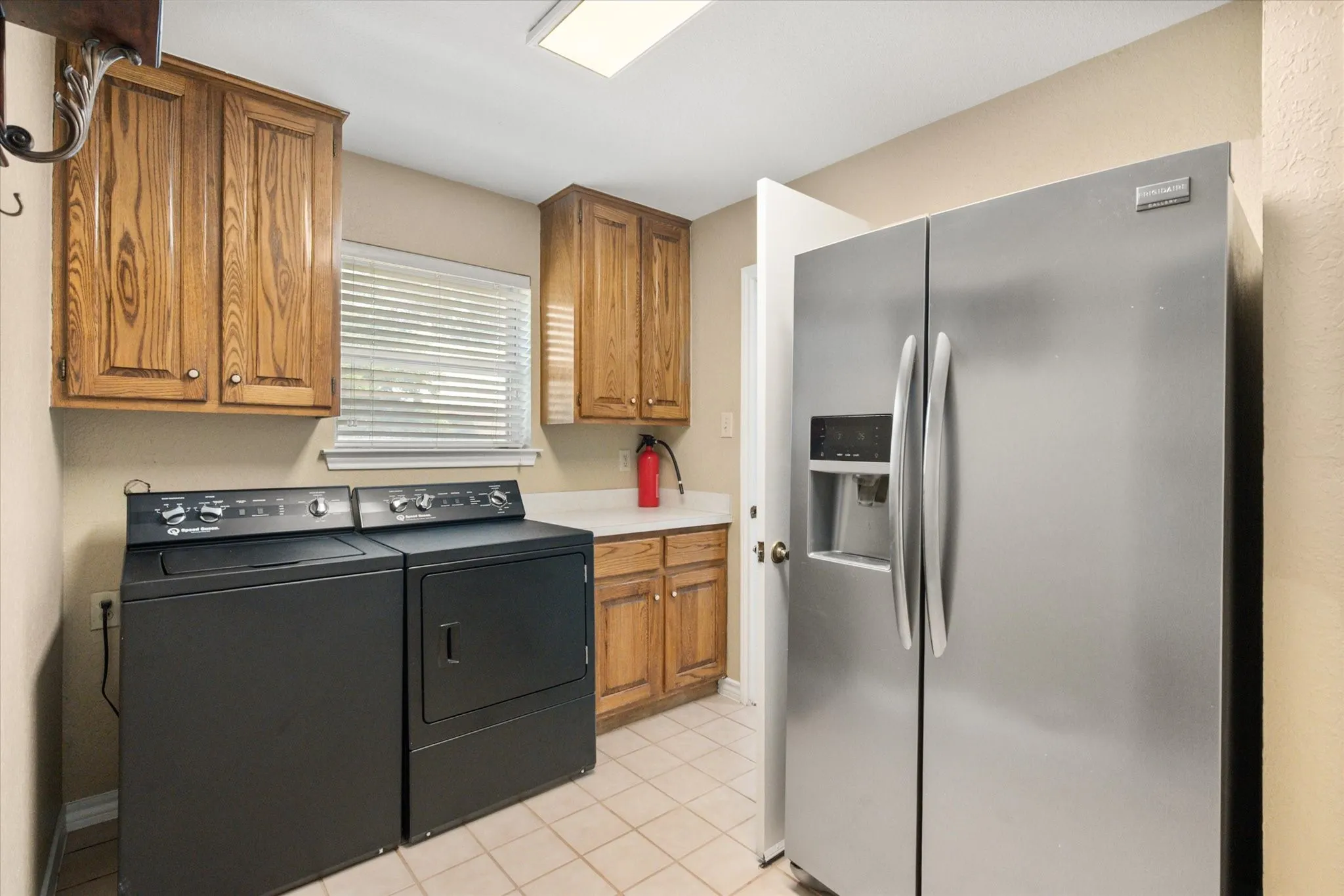 Laundry room with room for extra refrigerator