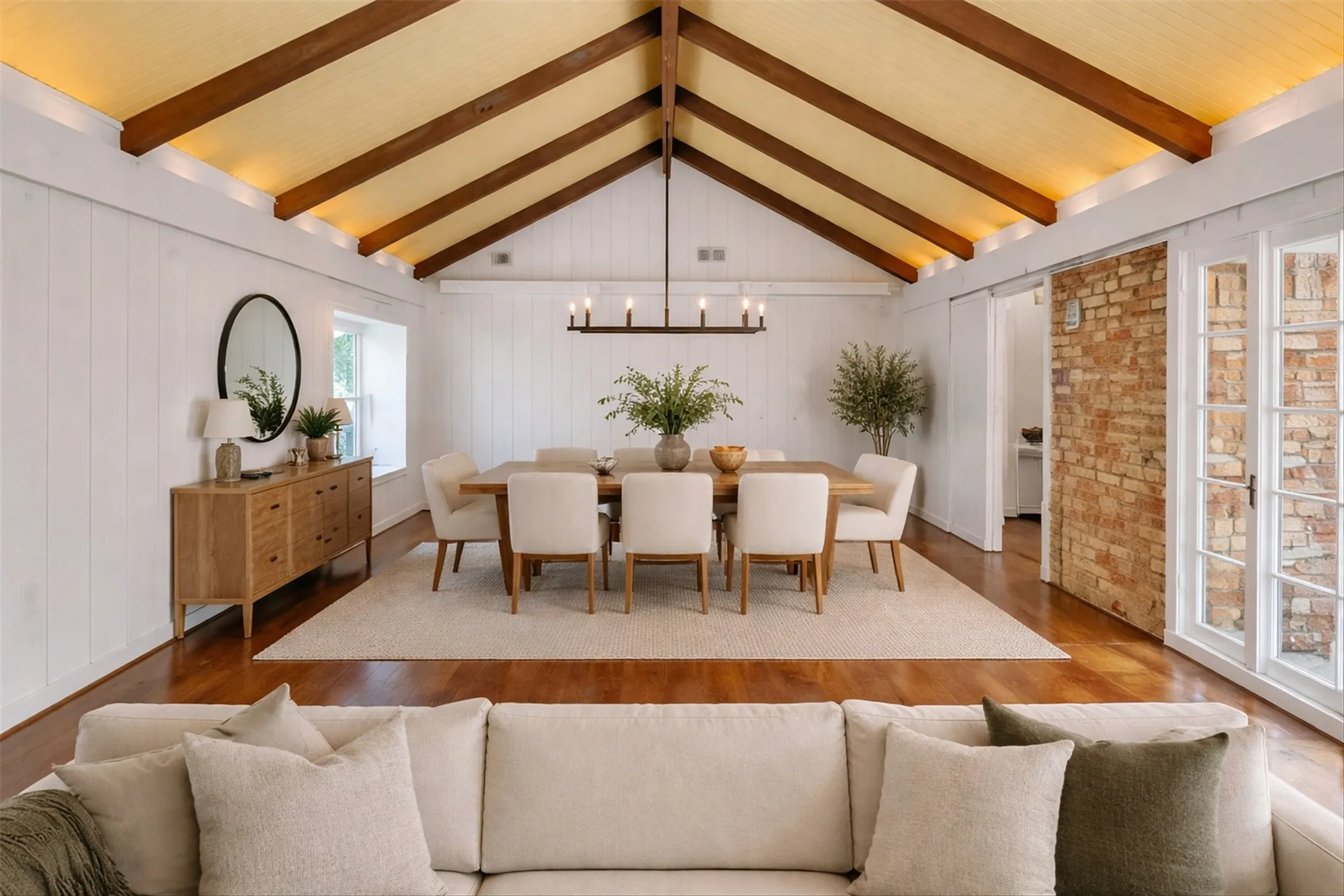 Vaulted ceiling with exposed wood beams and wood-finish paneling