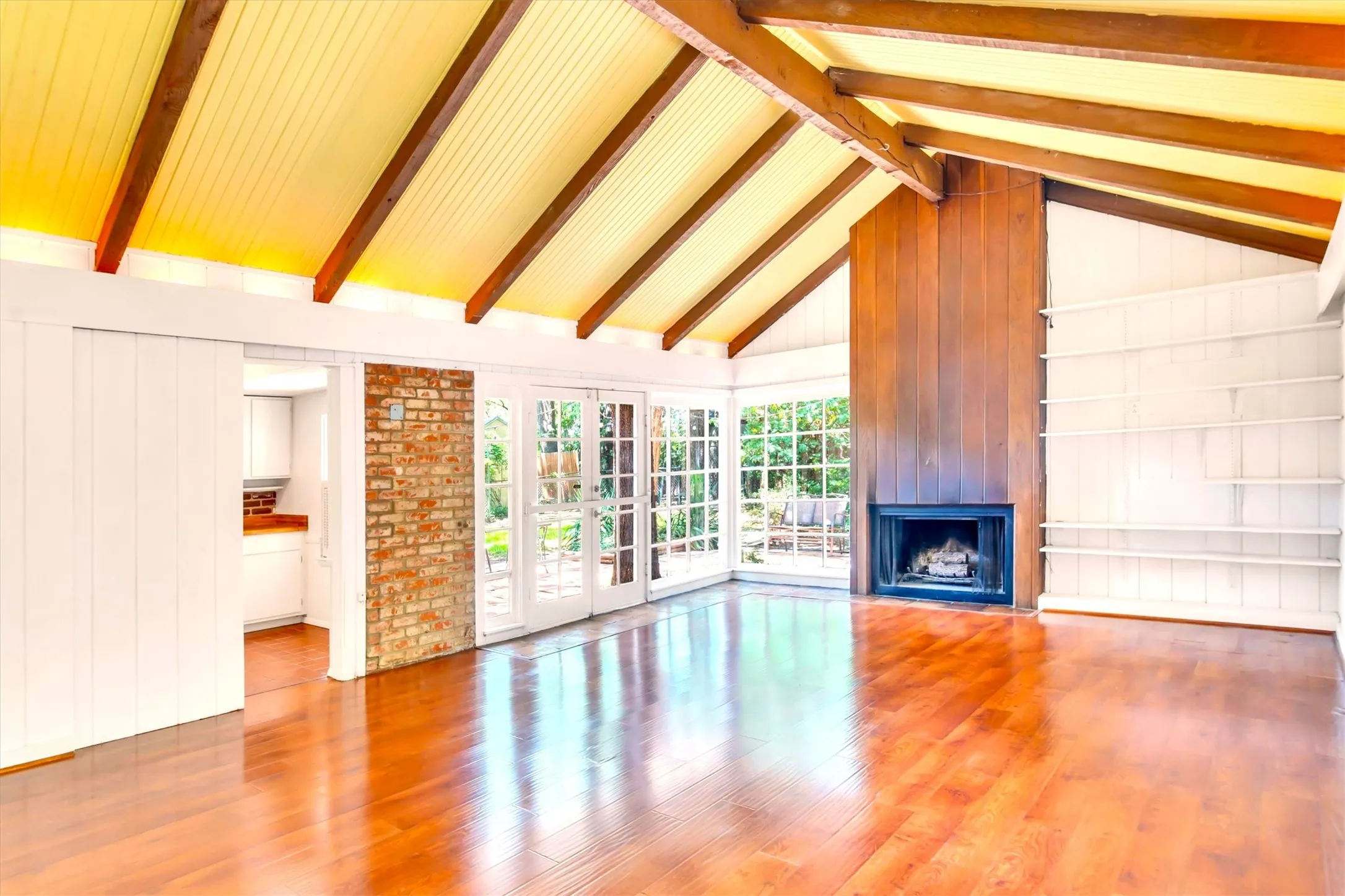 Vaulted wood-beamed ceiling with beadboard paneling