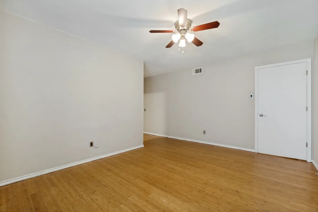 Light wood-finish flooring extending throughout the space