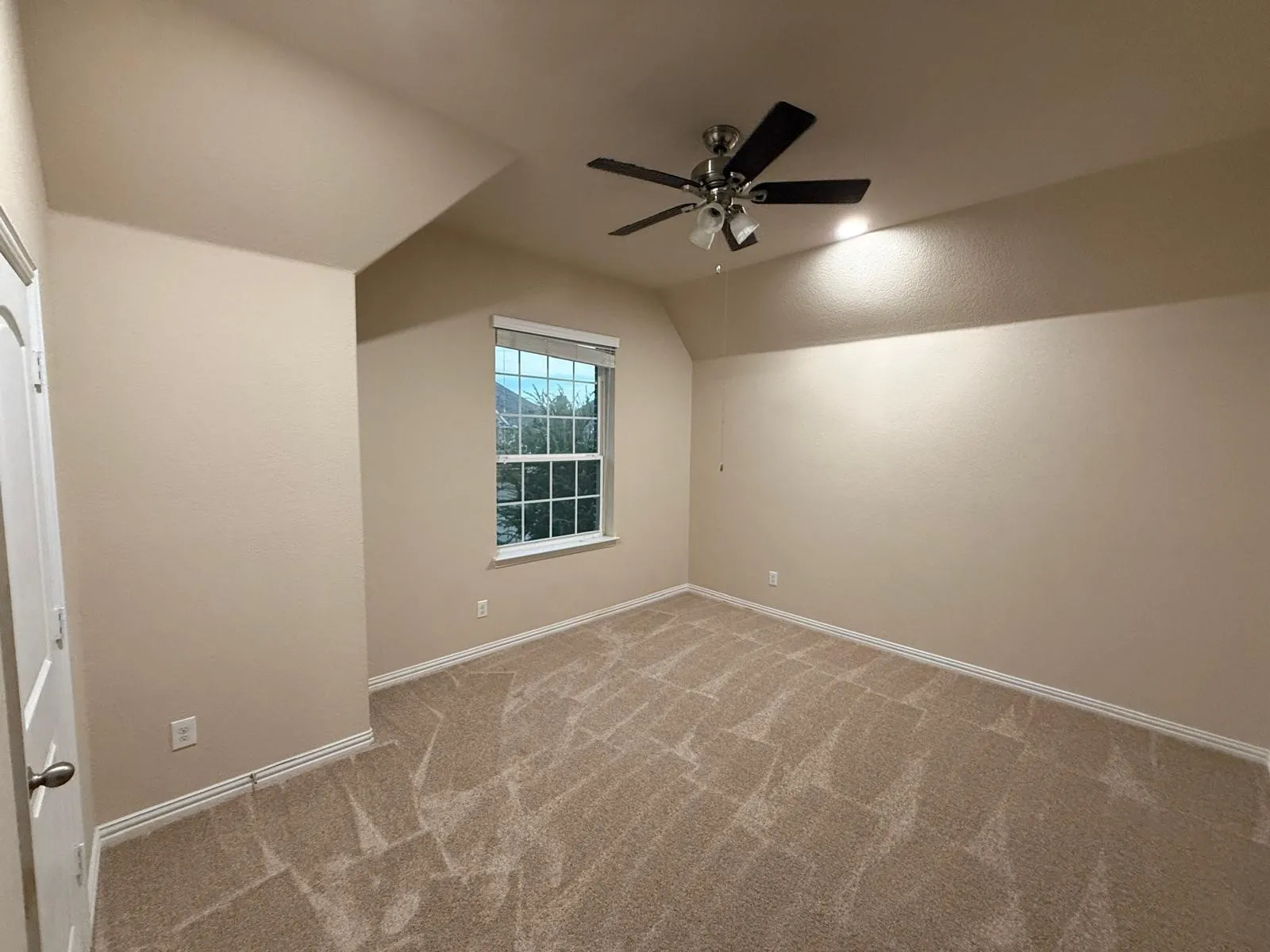 Carpeted room with a ceiling fan, a window with blinds, and neutral wall paint