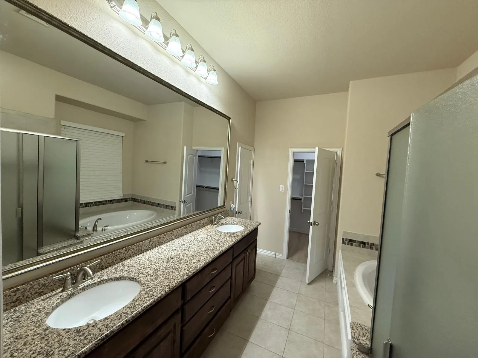 Dual vanity with granite countertops, undermount sinks, and brushed nickel fixtures
