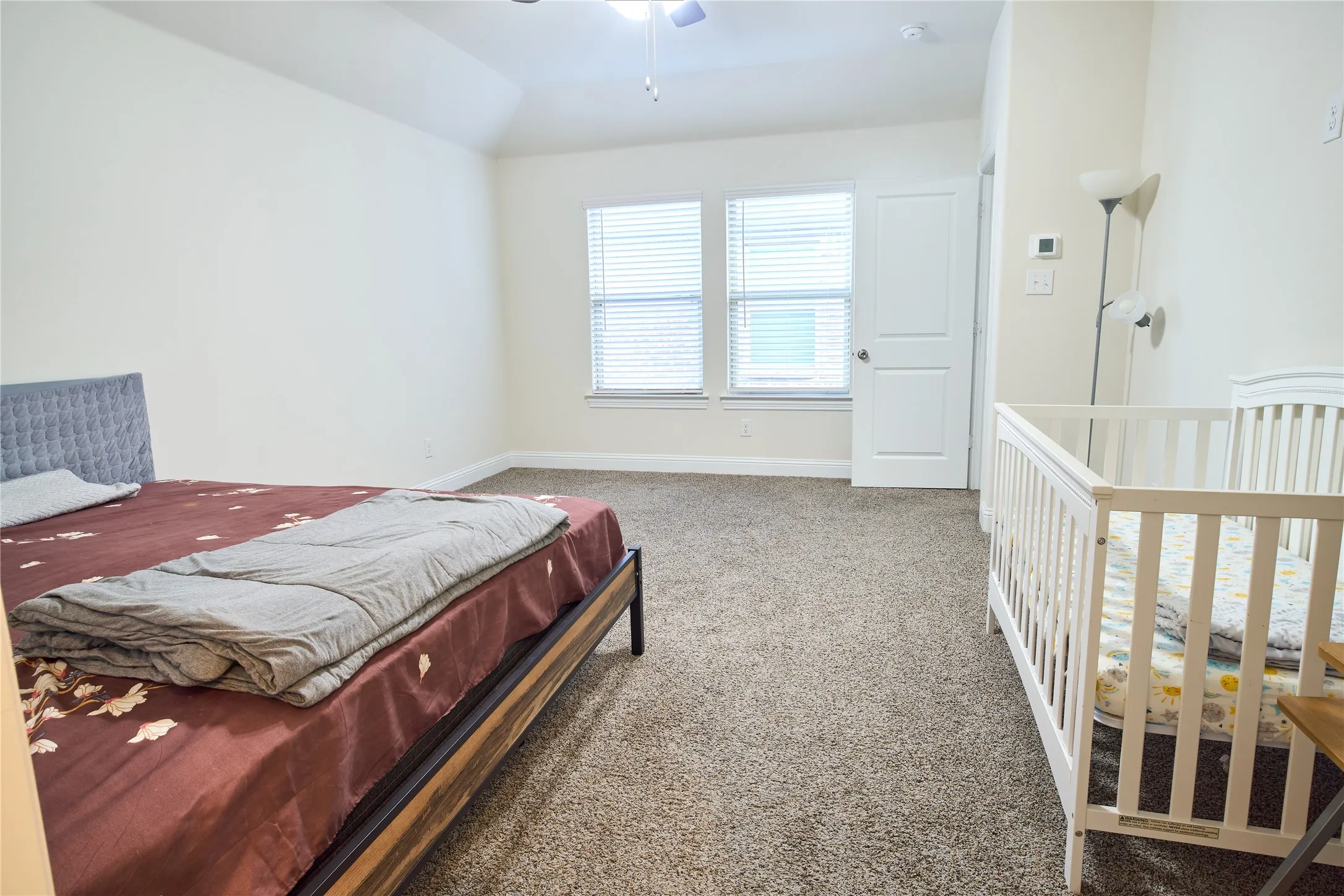 Spacious room featuring neutral carpeting and light-toned walls
