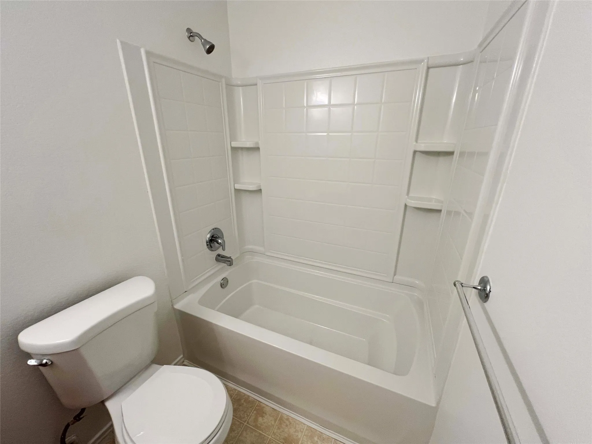 White shower-over-tub combination with integrated shelving