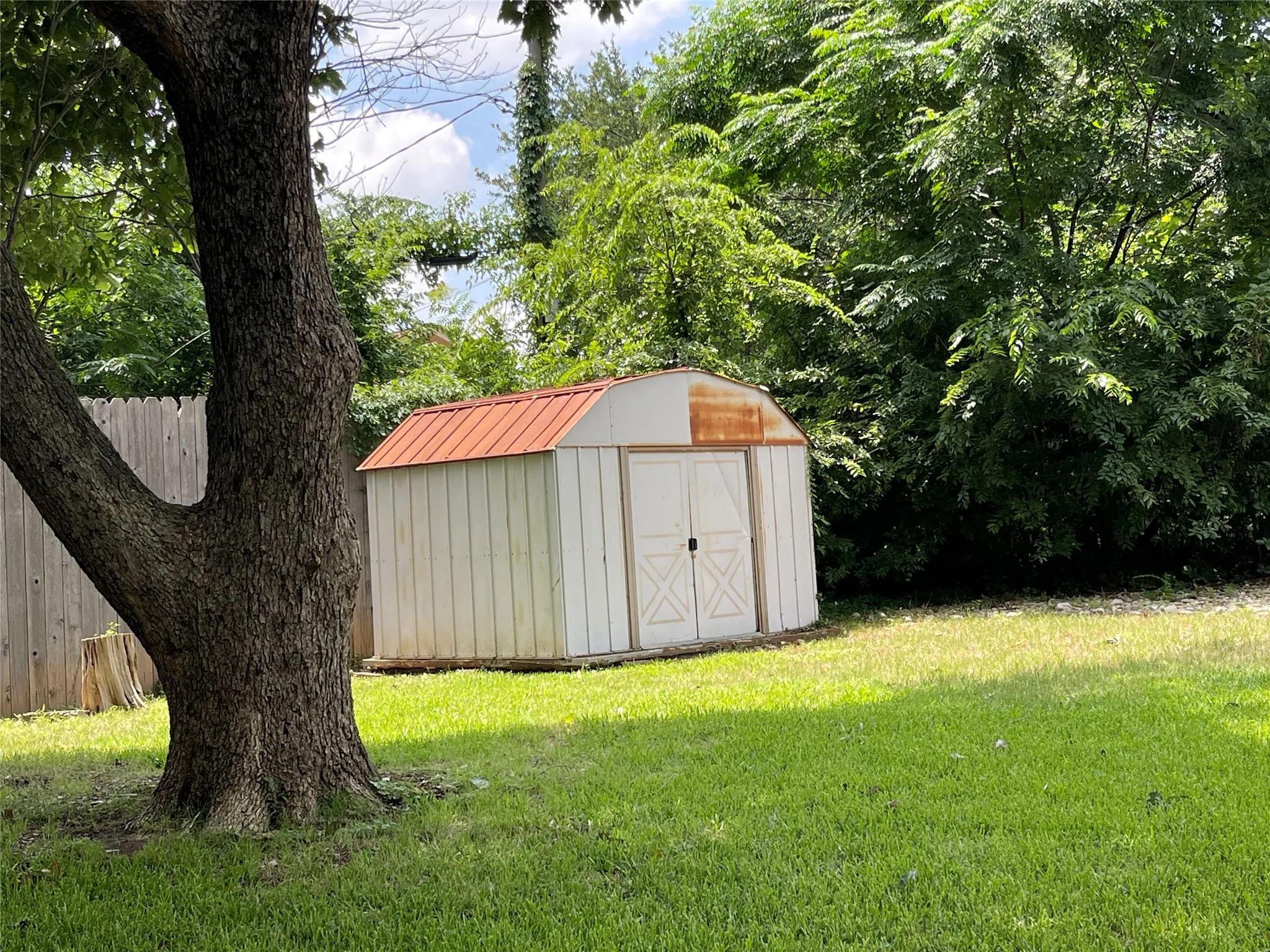 Metal Storage Building with sliding door on side of yard