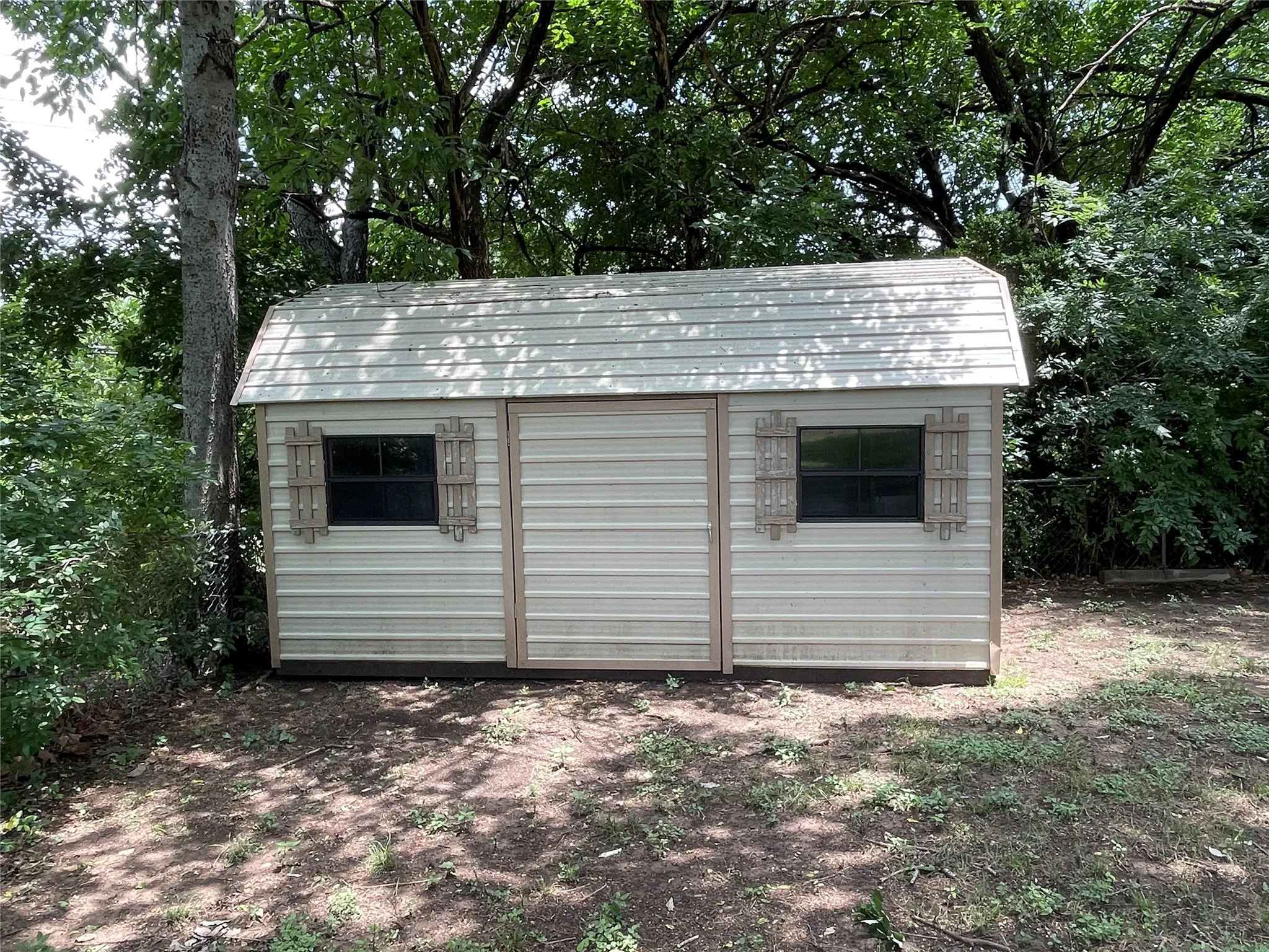 Wooden building at end of backyard for storage
