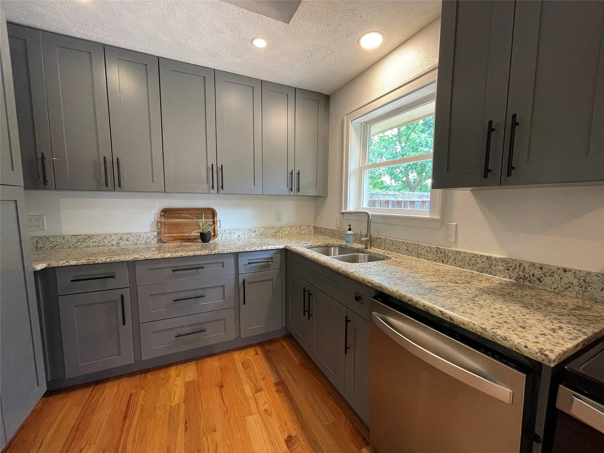 Granite Counters and handsome updated cabinetry. Stainless Steel appliances