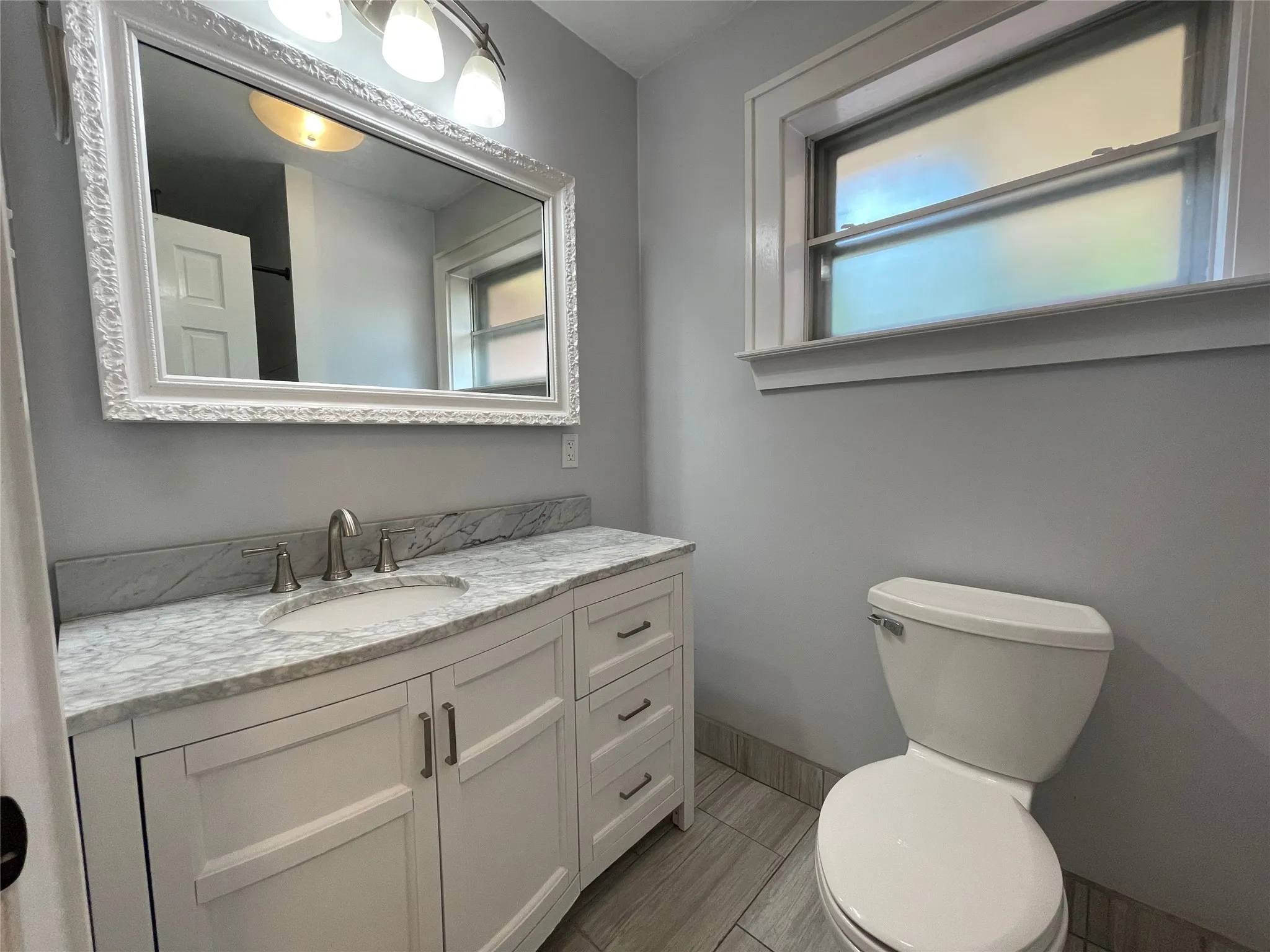 Bathroom shared by 2nd and 3rd Bedrooms. Large walk-in shower.