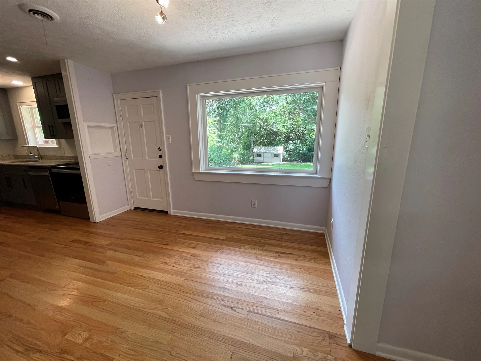 Beautiful backyard views from the oversized picture window. Backdoor opens onto the wood deck.