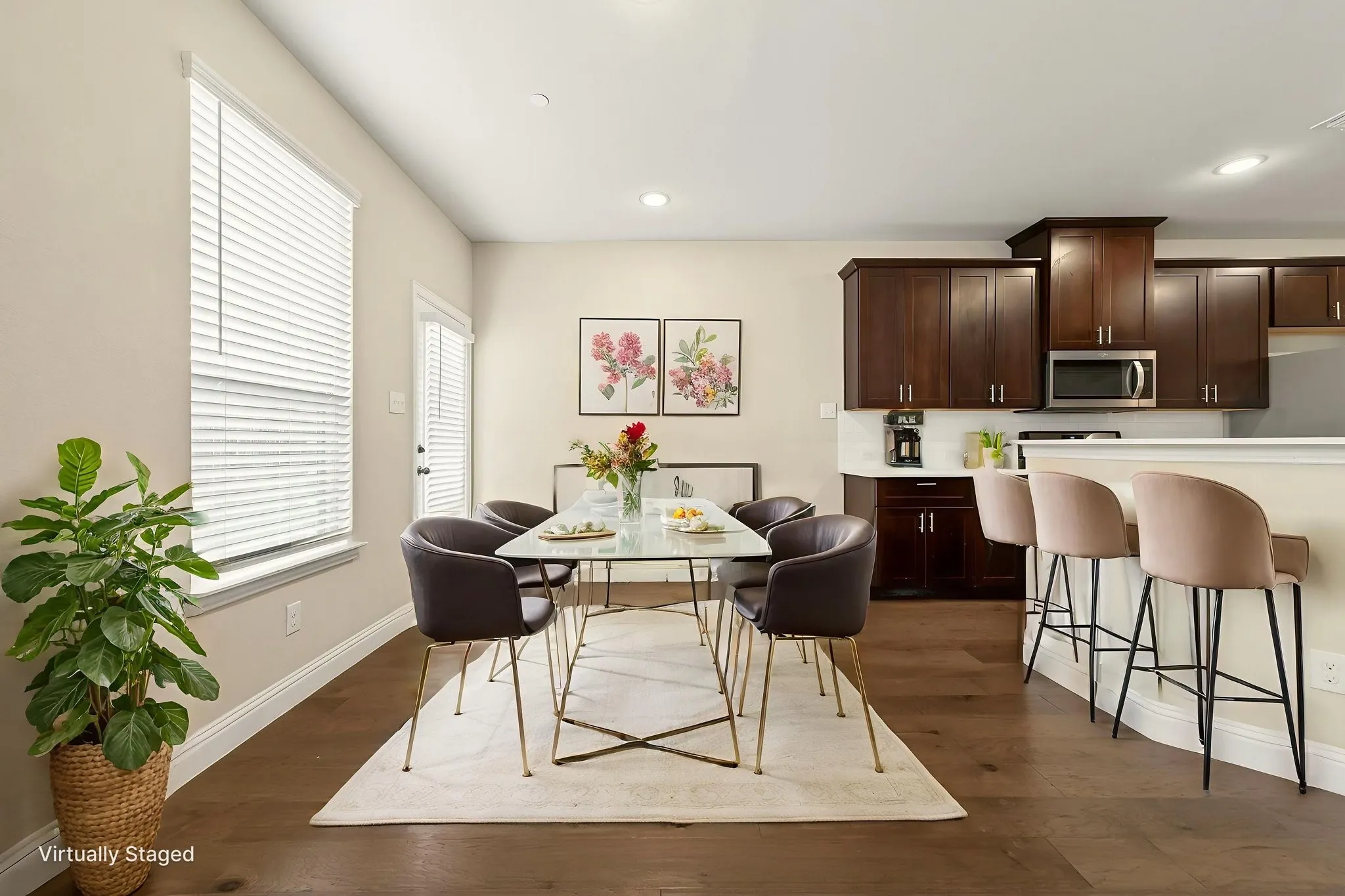 Open-concept living space featuring wood-finish flooring, recessed lighting, and a kitchen with dark wood cabinetry