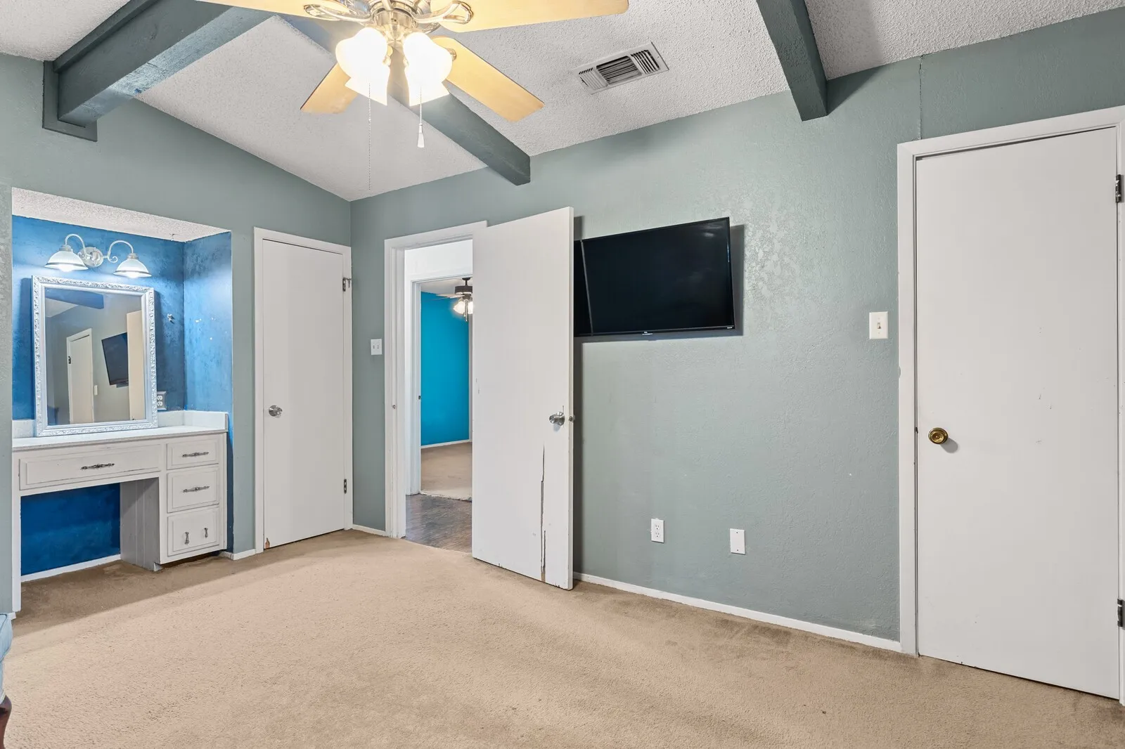 Room with vaulted ceiling, exposed beams, and a ceiling fan
