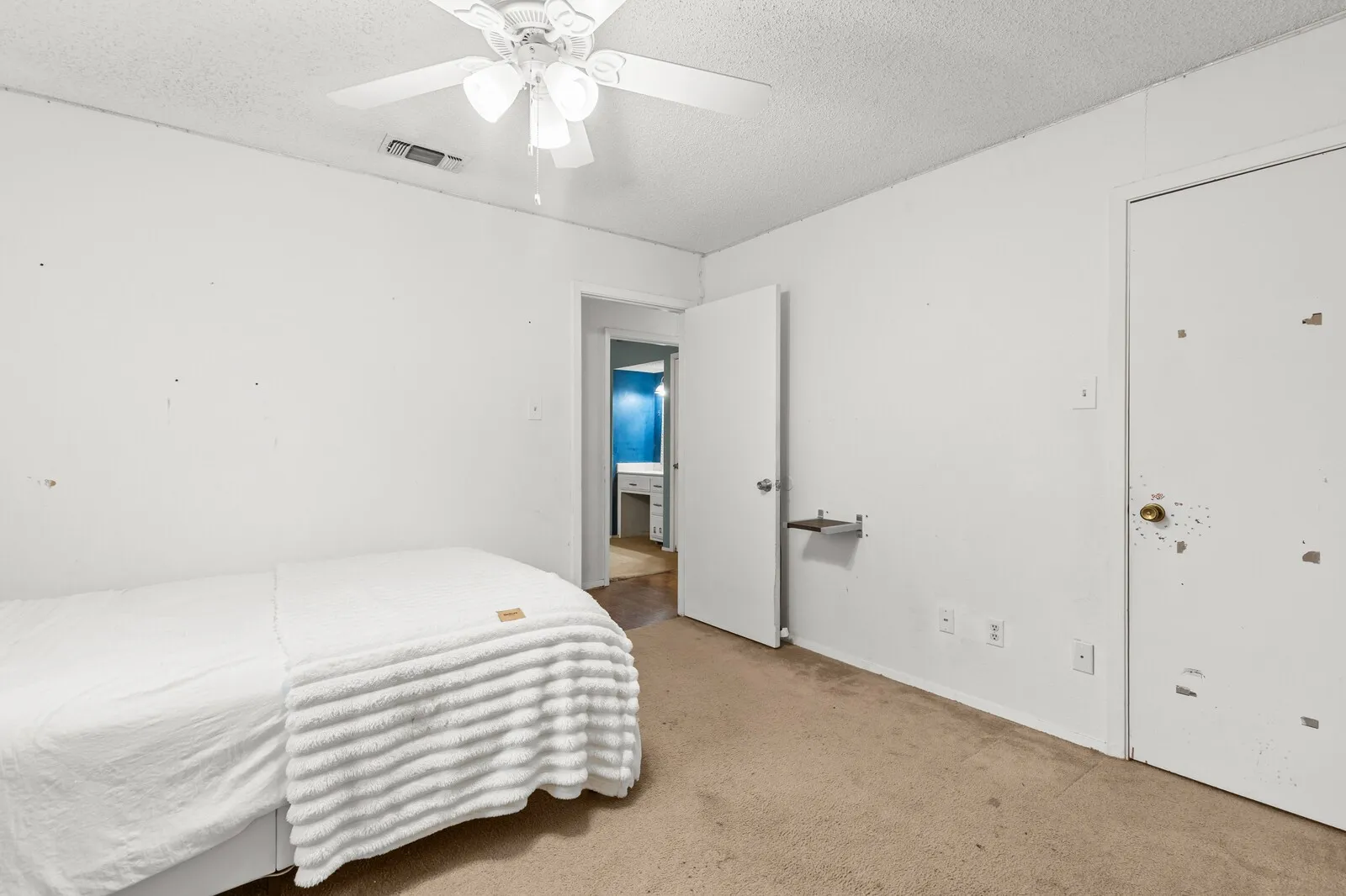 Carpeted room featuring a ceiling fan with integrated lighting
