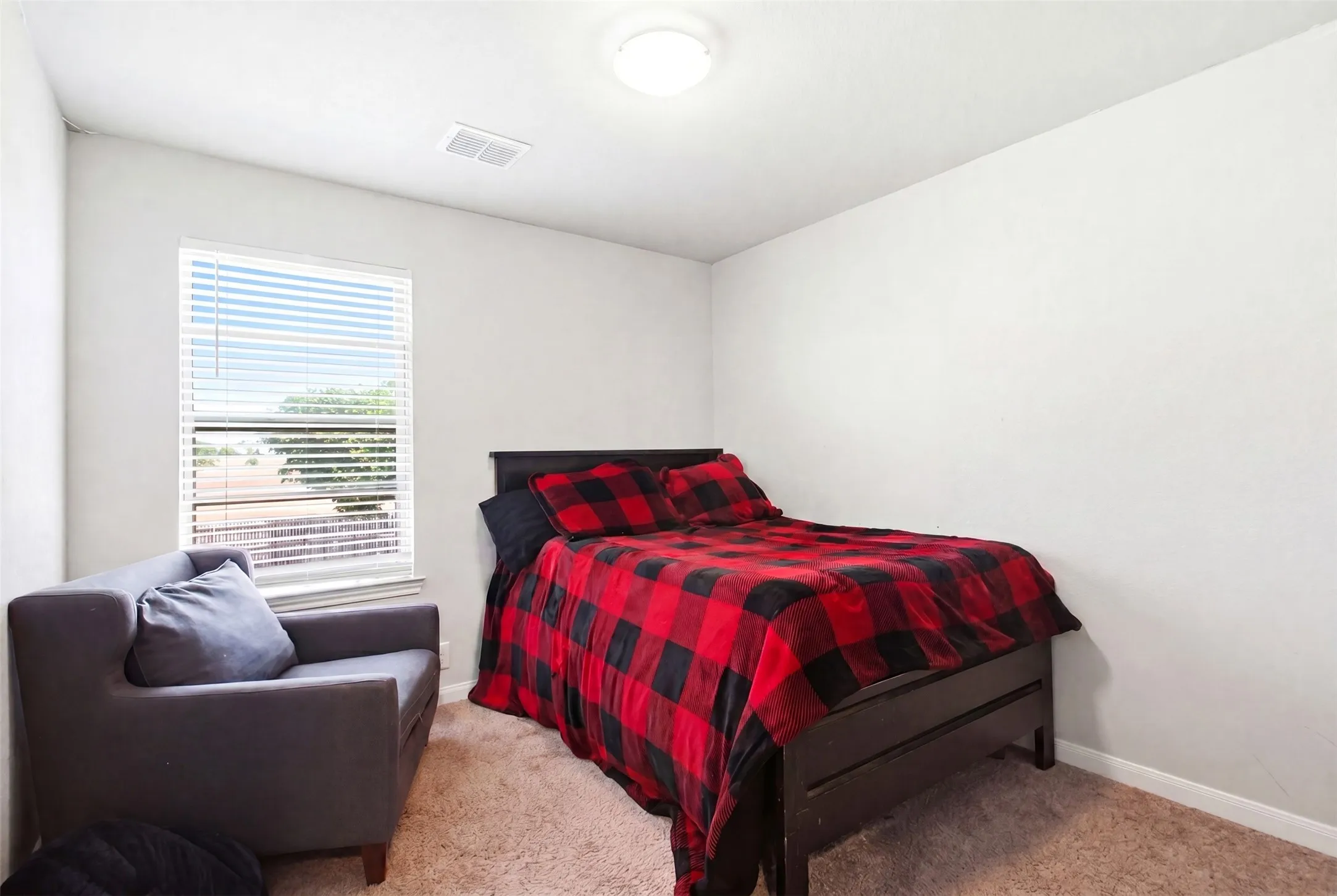 Room with light gray walls, a window featuring horizontal blinds, and a built-in overhead light fixture