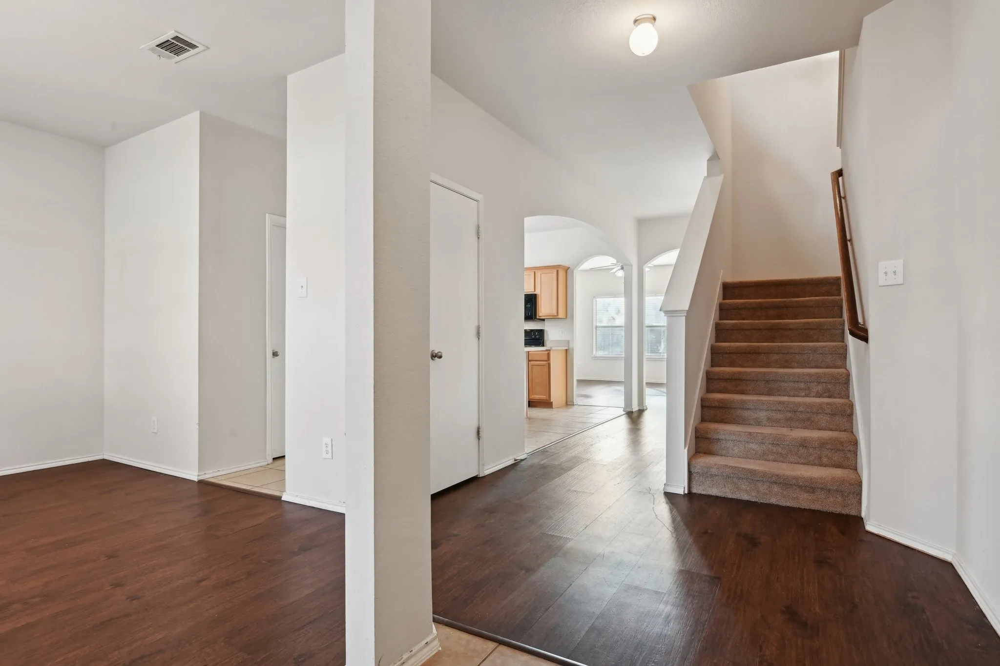 Entrance foyer with hardwood / wood-style floors