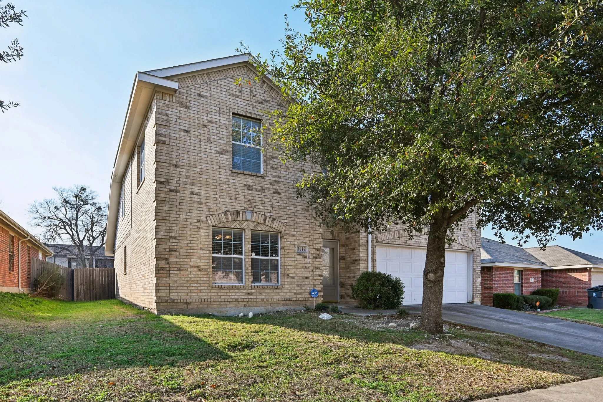 View of front of home featuring a garage and a front yard