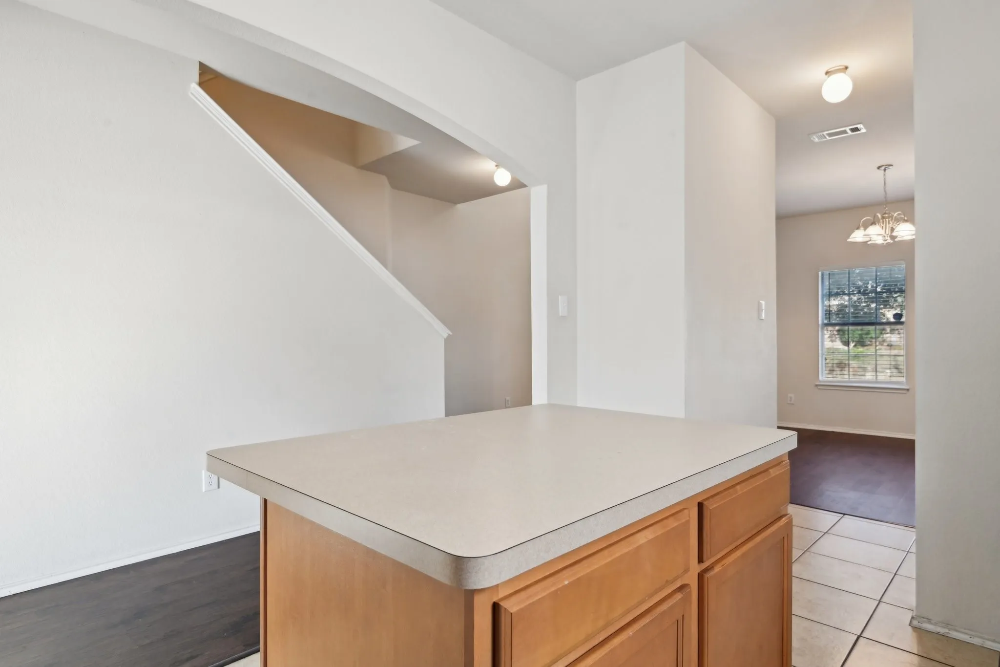 Kitchen with a center island and light tile patterned floors