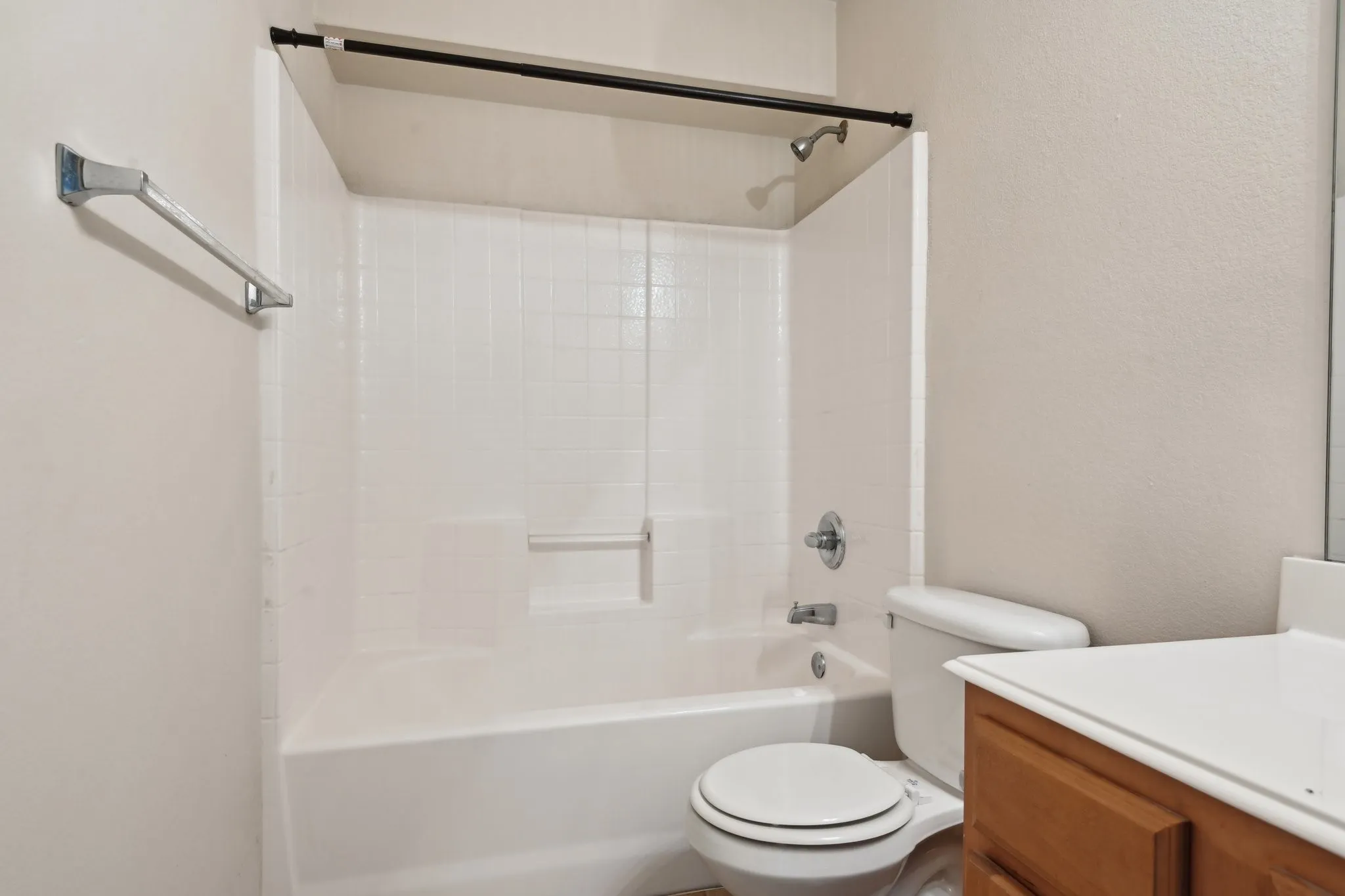 Full bathroom featuring shower / bath combination, vanity, and toilet