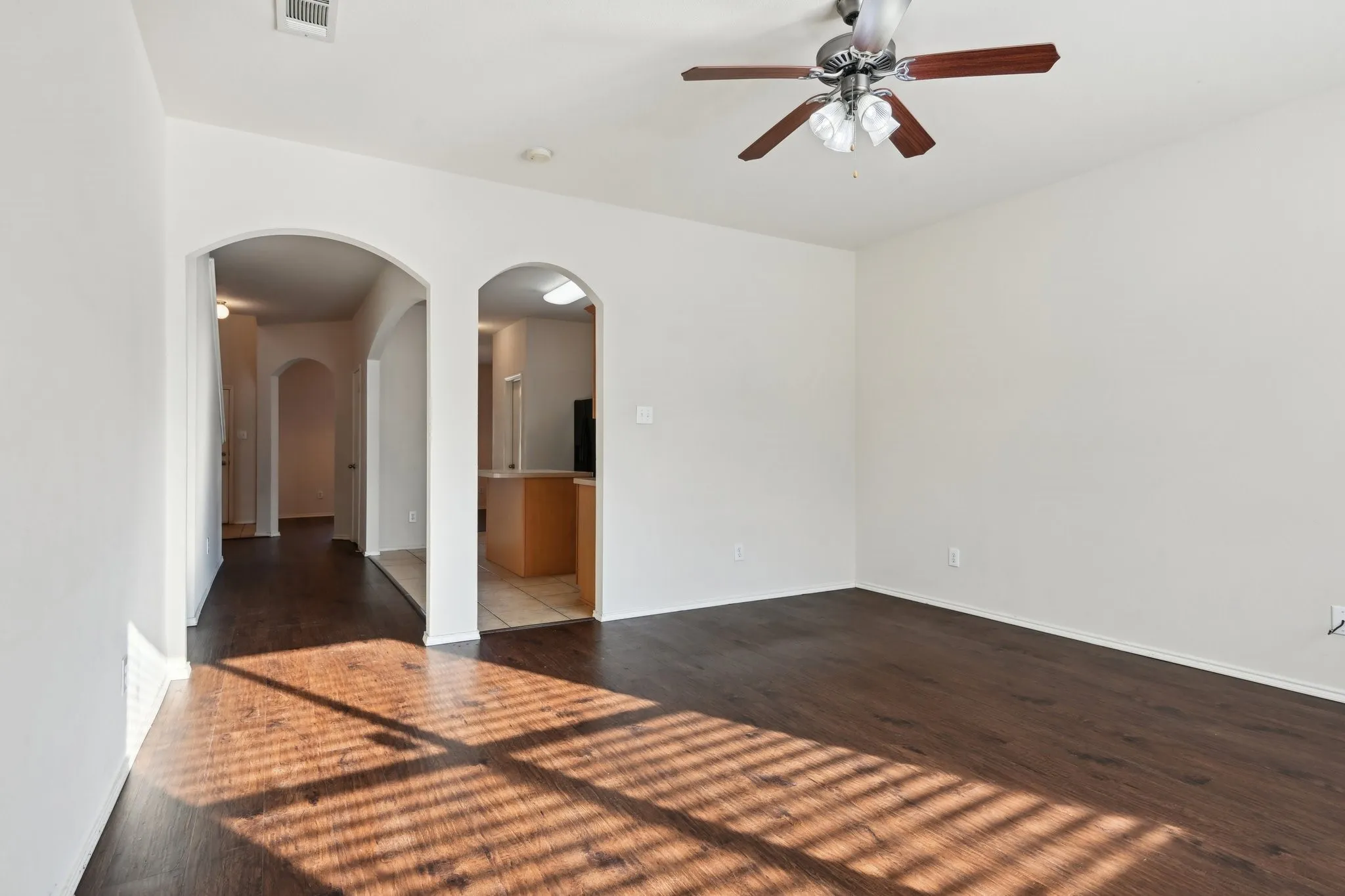 room with dark hardwood / wood-style floors and ceiling fan